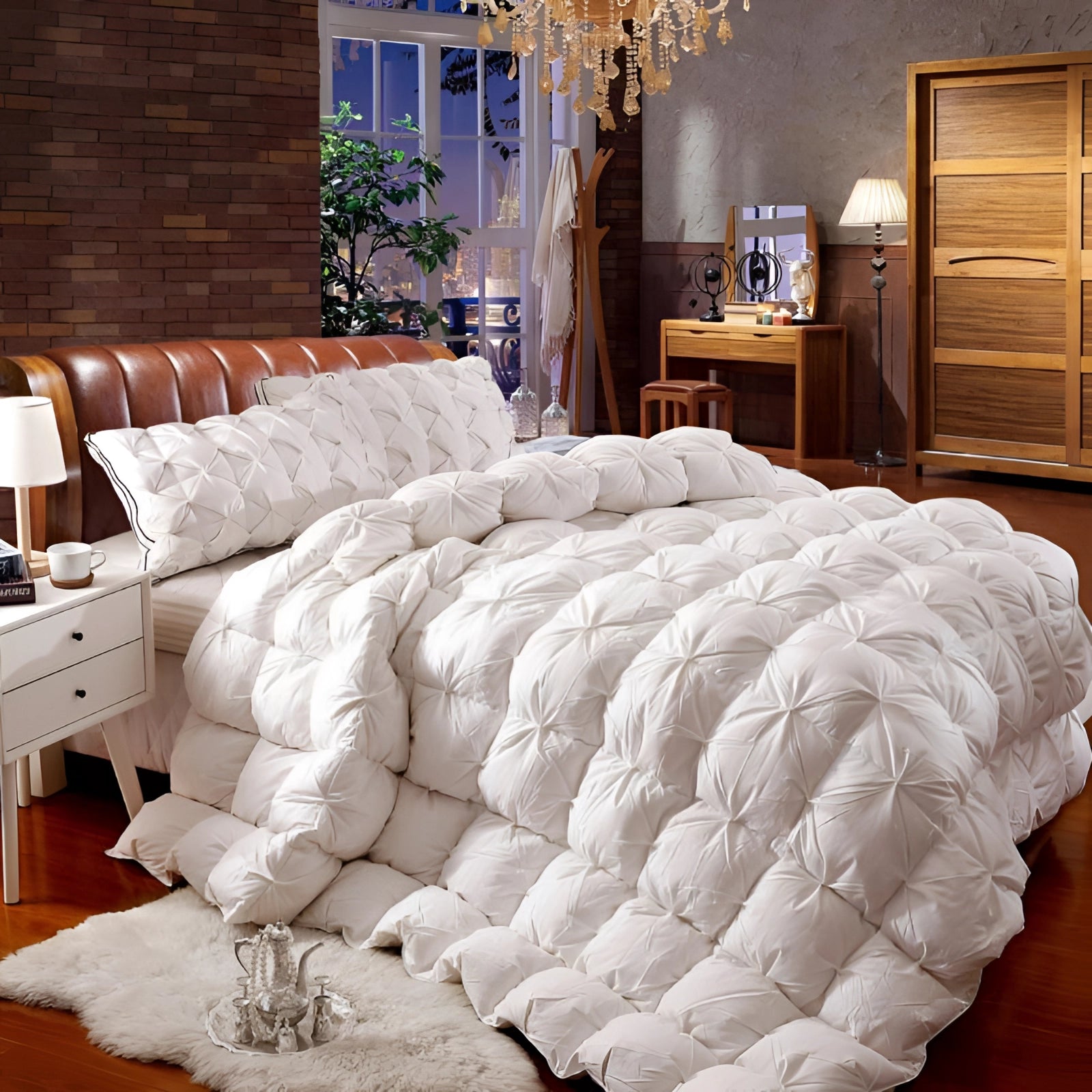 Luxury white pinch pleat comforter set displayed on a California King bed in a well-lit, elegantly designed bedroom. The textured bedding adds a touch of sophistication to the interior decor, complementing the light wood furnishings and modern cabinetry.