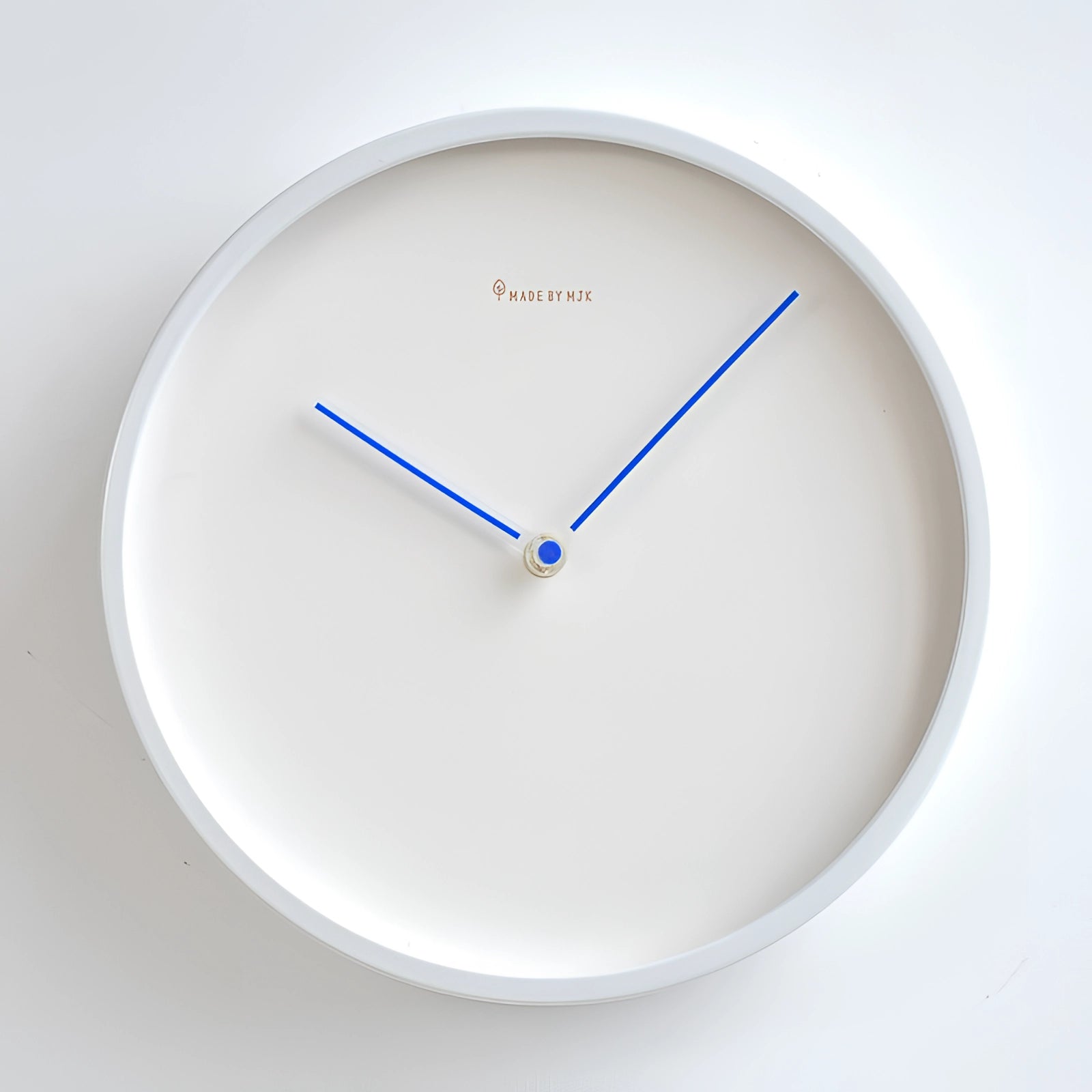 Minimalist ceramic wall clock in electric blue with a modern, no numbers design, measuring 30cm in diameter, suitable for contemporary interior decor.