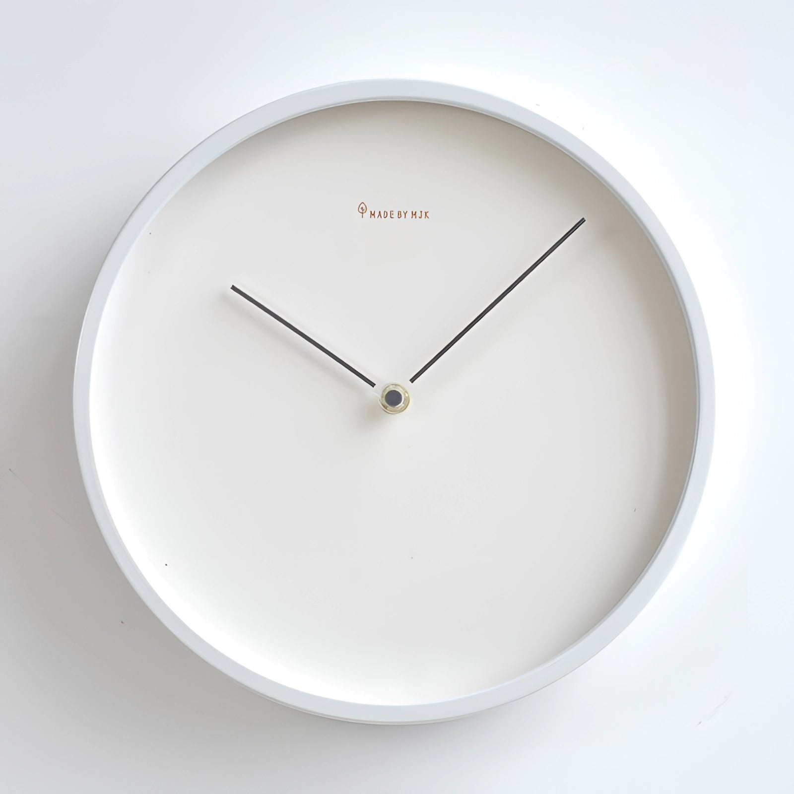Gray minimalist ceramic wall clock with no numbers, featuring a modern design and circular shape, measuring 30cm in diameter, suitable for interior decor.