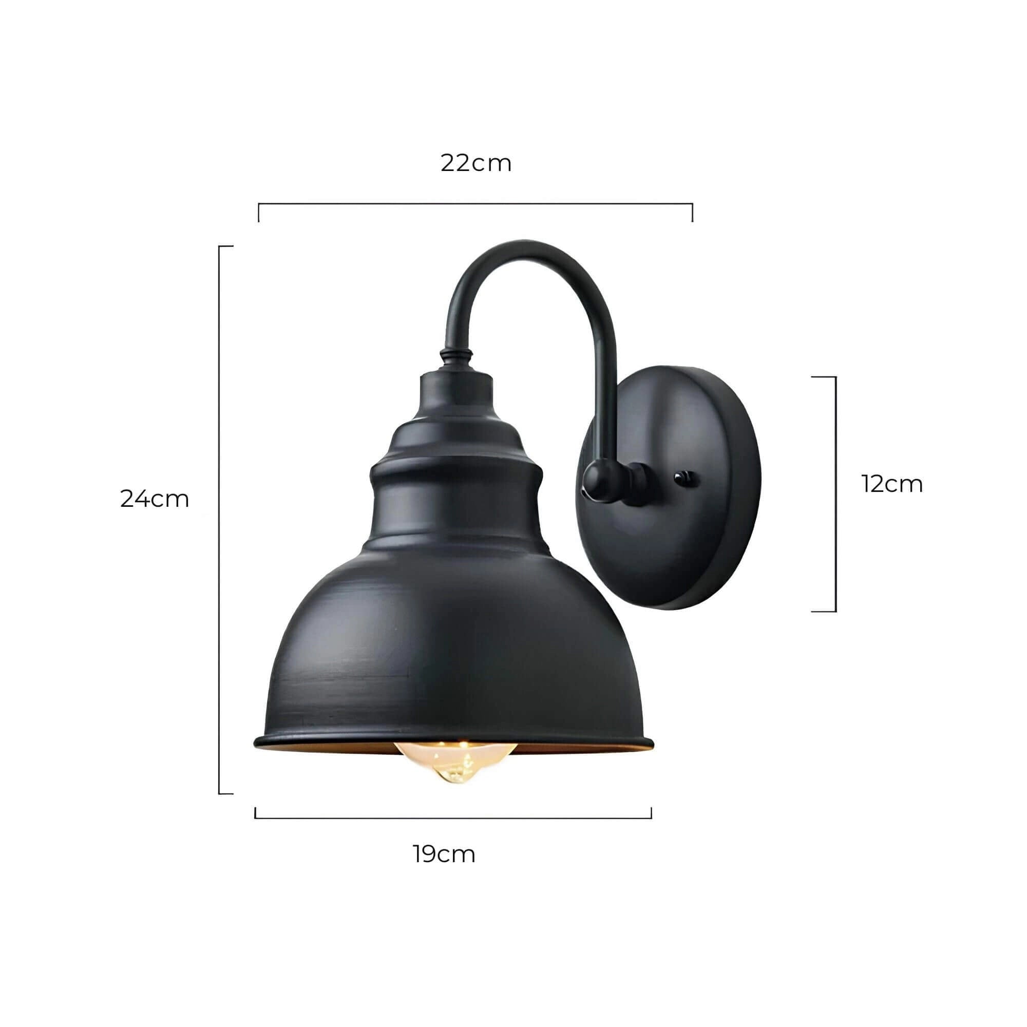 Matte black vintage industrial wall sconce with an exposed Edison bulb, mounted on a wall, showcasing its sleek and classic design elements.