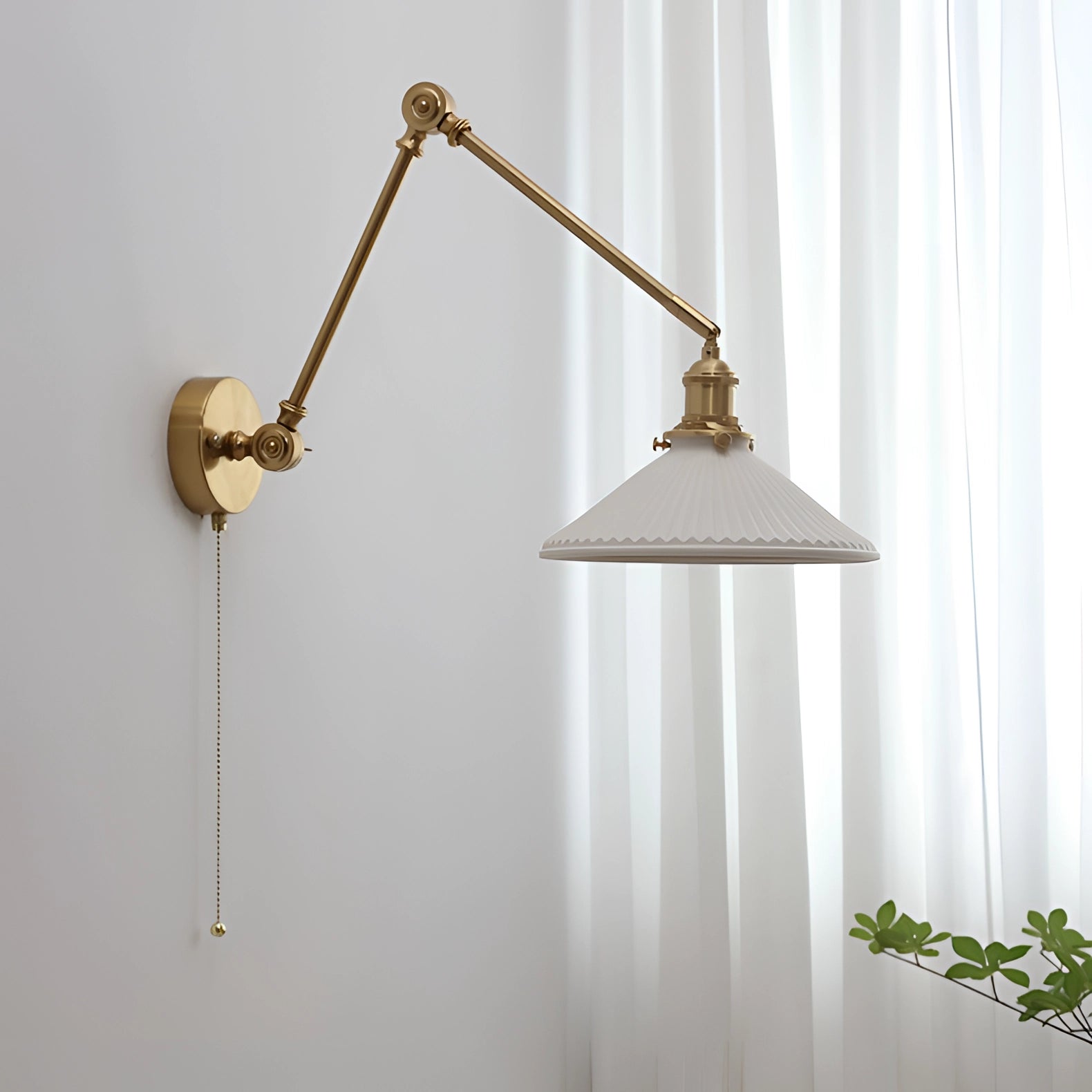 Mid-century adjustable brass wall sconce with a cone-shaped lampshade mounted on a wall beside a wooden shelf adorned with plants and decorative items.