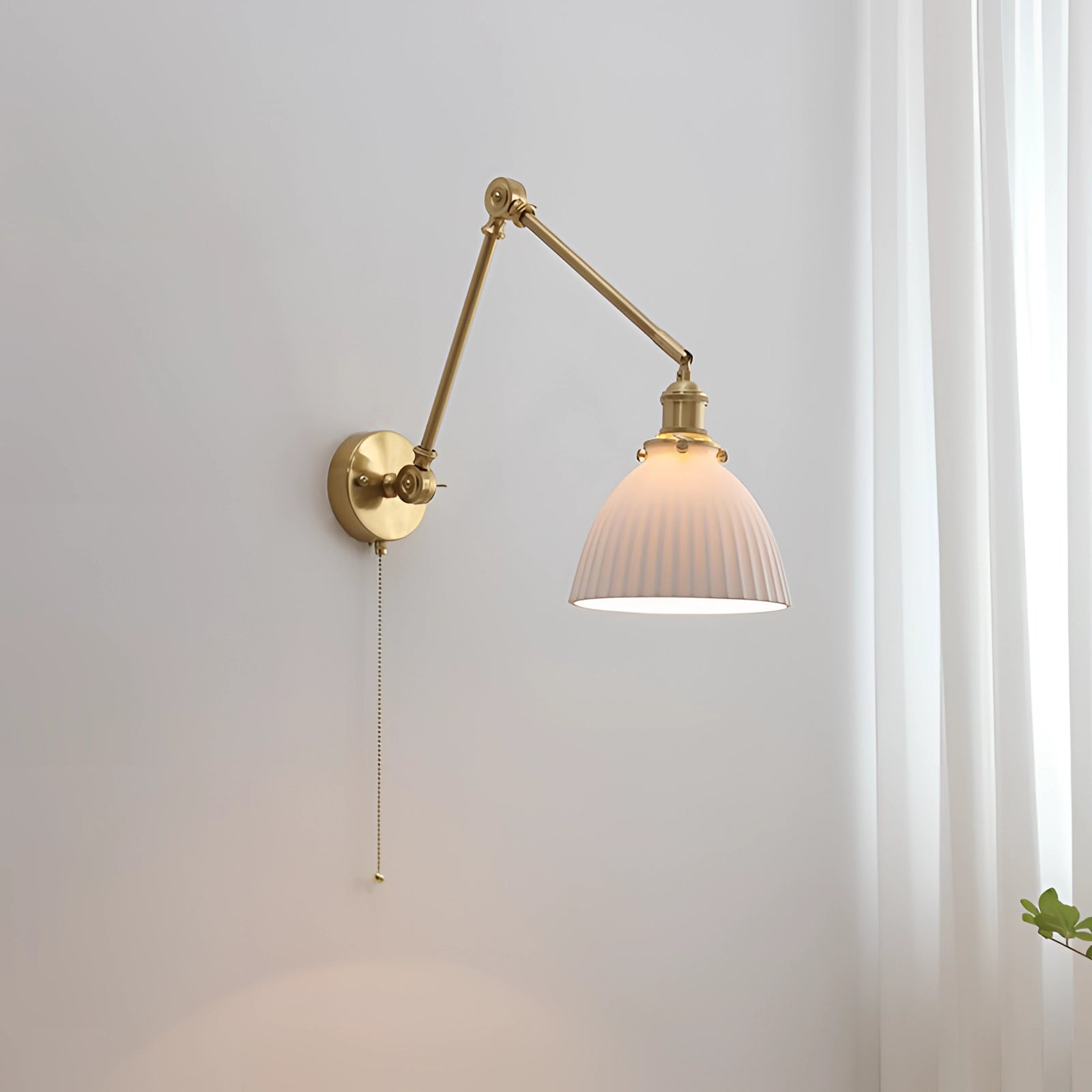 Mid-century adjustable brass wall sconce with a bell-shaped lampshade, featuring a vintage design and crafted from metal with wood accents.