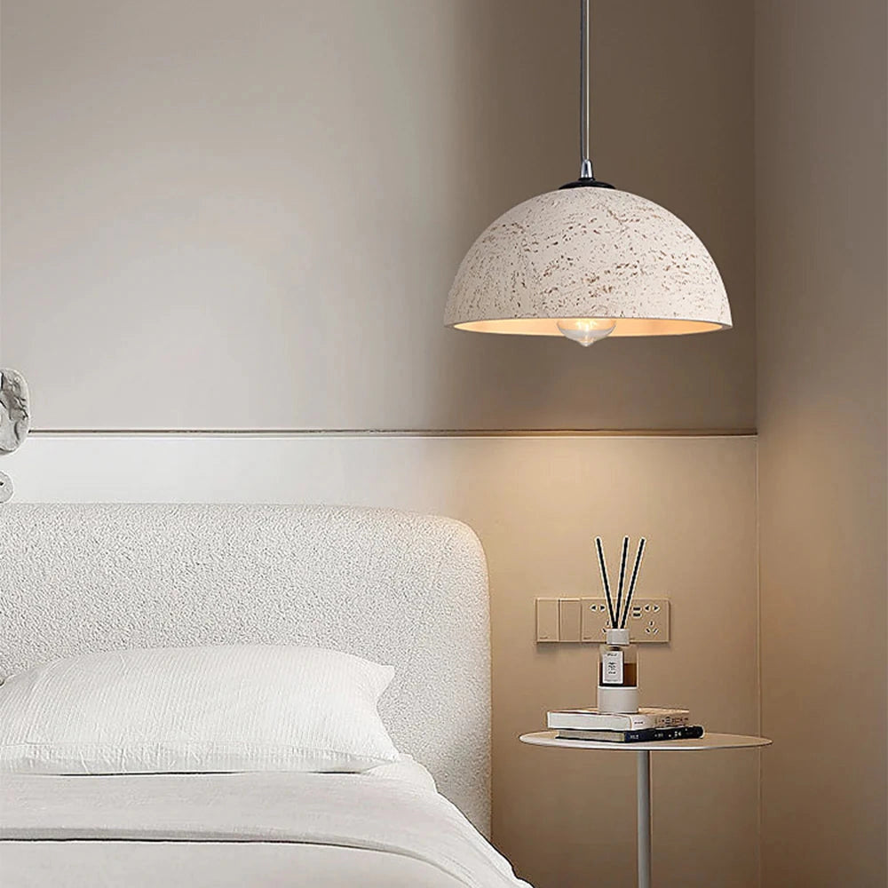 Mid-century minimalist LED pendant light with a speckled white shade, featuring a sleek design ideal for modern interior spaces, hanging above a wooden table.