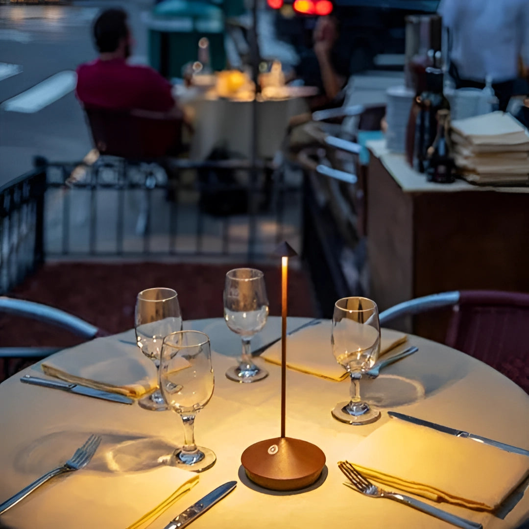 Minimalist arrow-shaped LED desk lamp on a modern table setting, highlighting its sleek design and contemporary decor appeal.