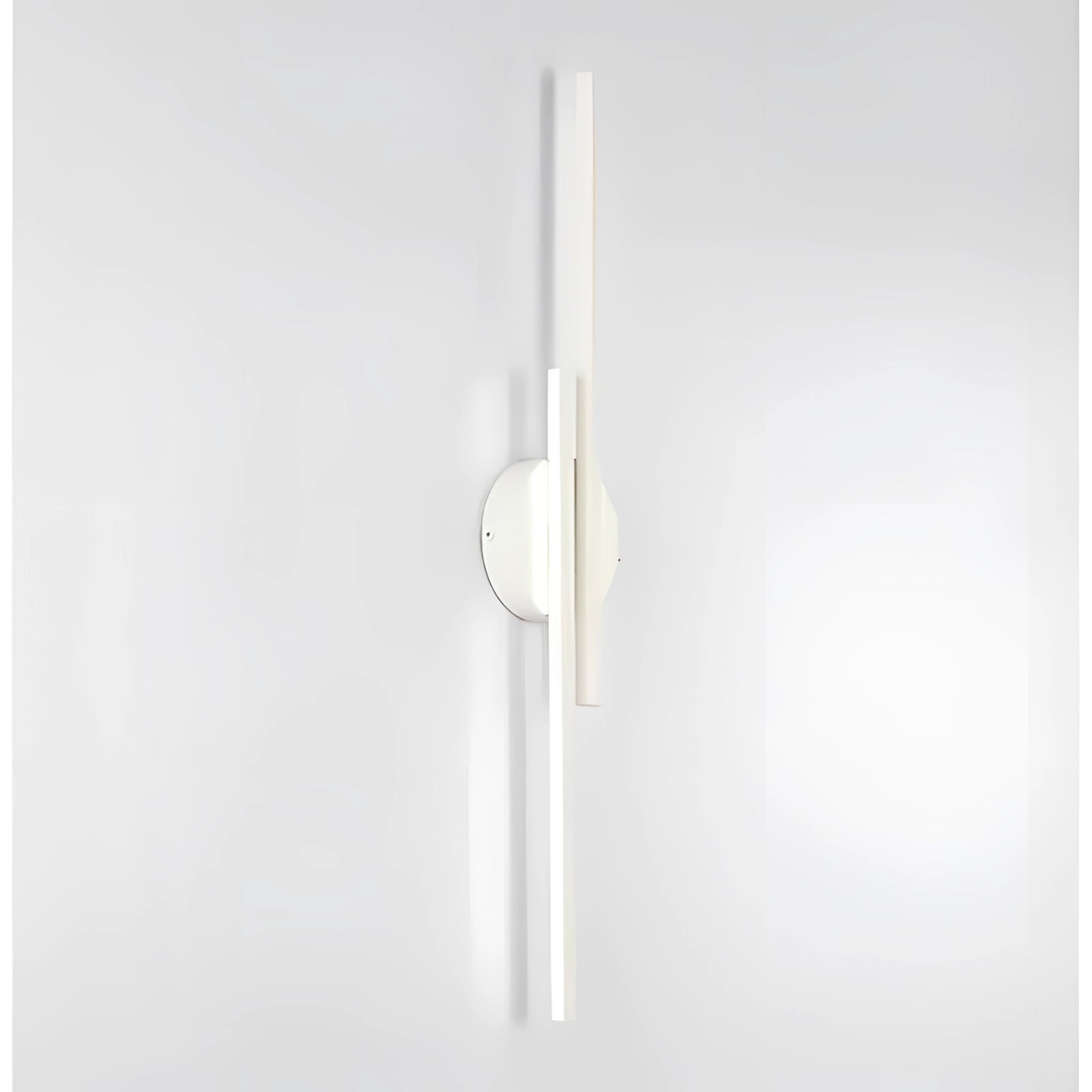 Minimalist black LED wall sconce with a modern vertical metal design, mounted on a wall, showcasing its sleek and contemporary style.