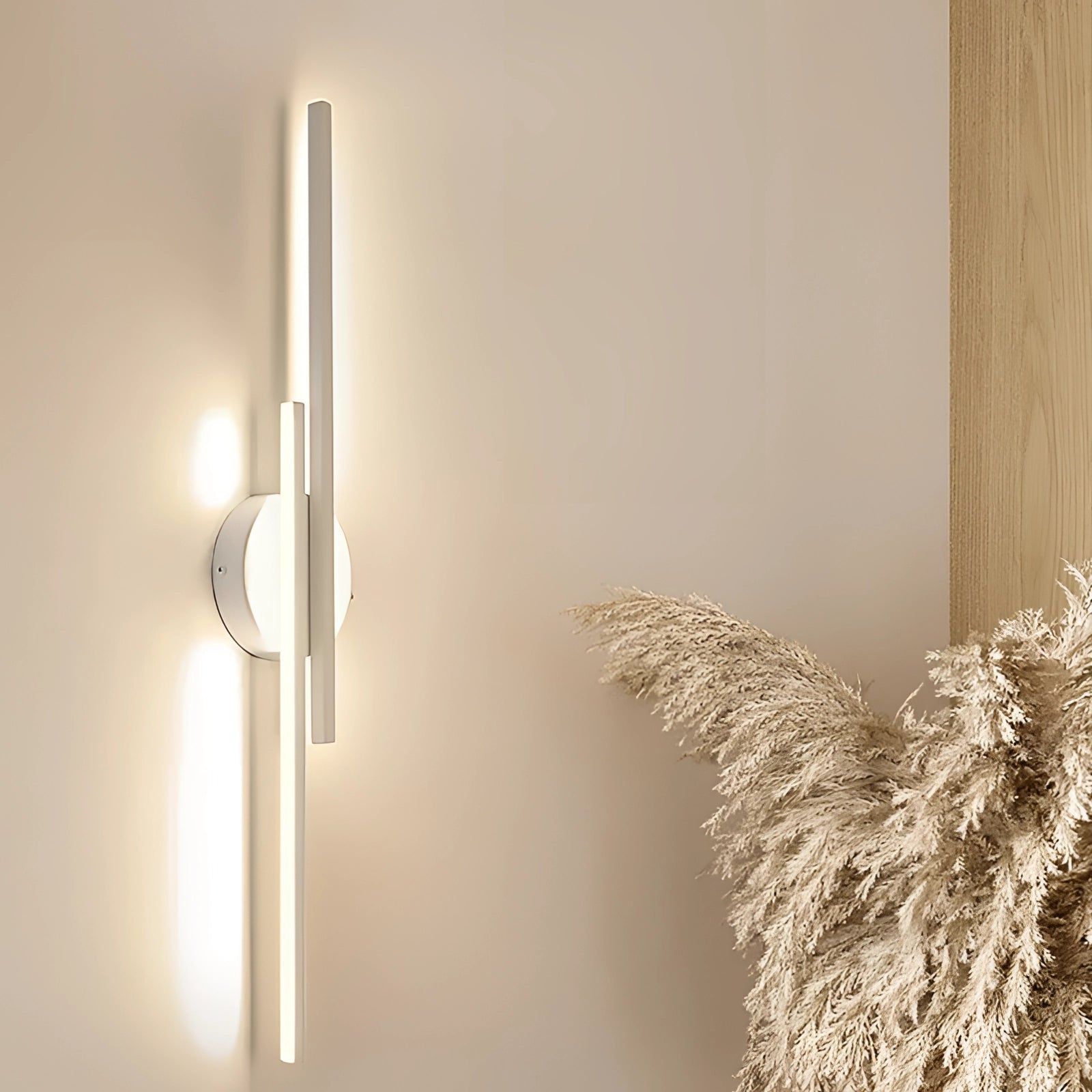 Minimalist black LED wall sconce with modern vertical metal design, featuring a dimmable white light and sleek aesthetic, mounted on a plain wall next to a wooden door with a metal handle.