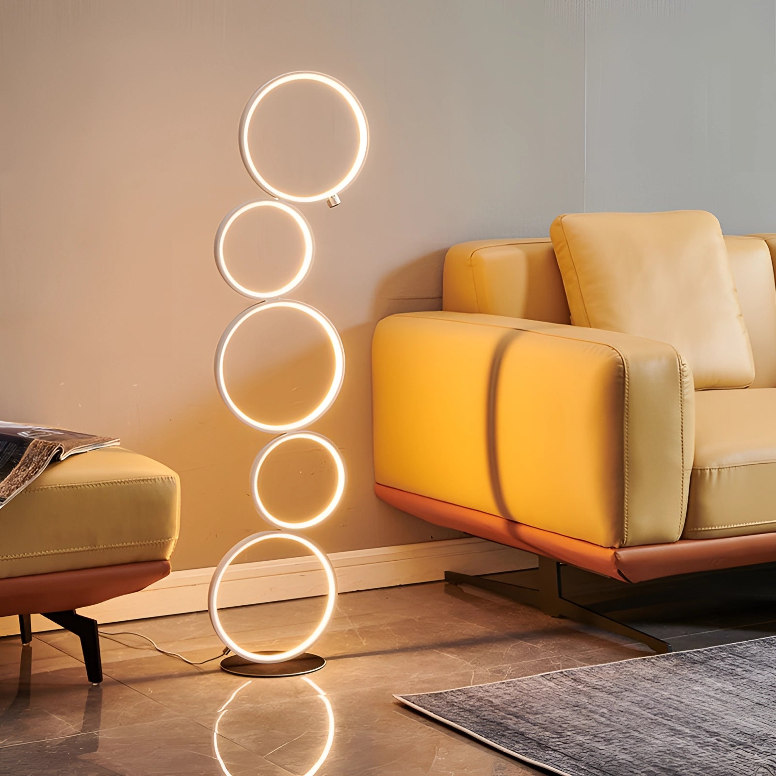Minimalist black metal circular wall rack with a modern geometric frame, featuring five warm white lights, elegantly displayed in a contemporary living room setting with a comfortable couch, wooden table, and stylish flooring.