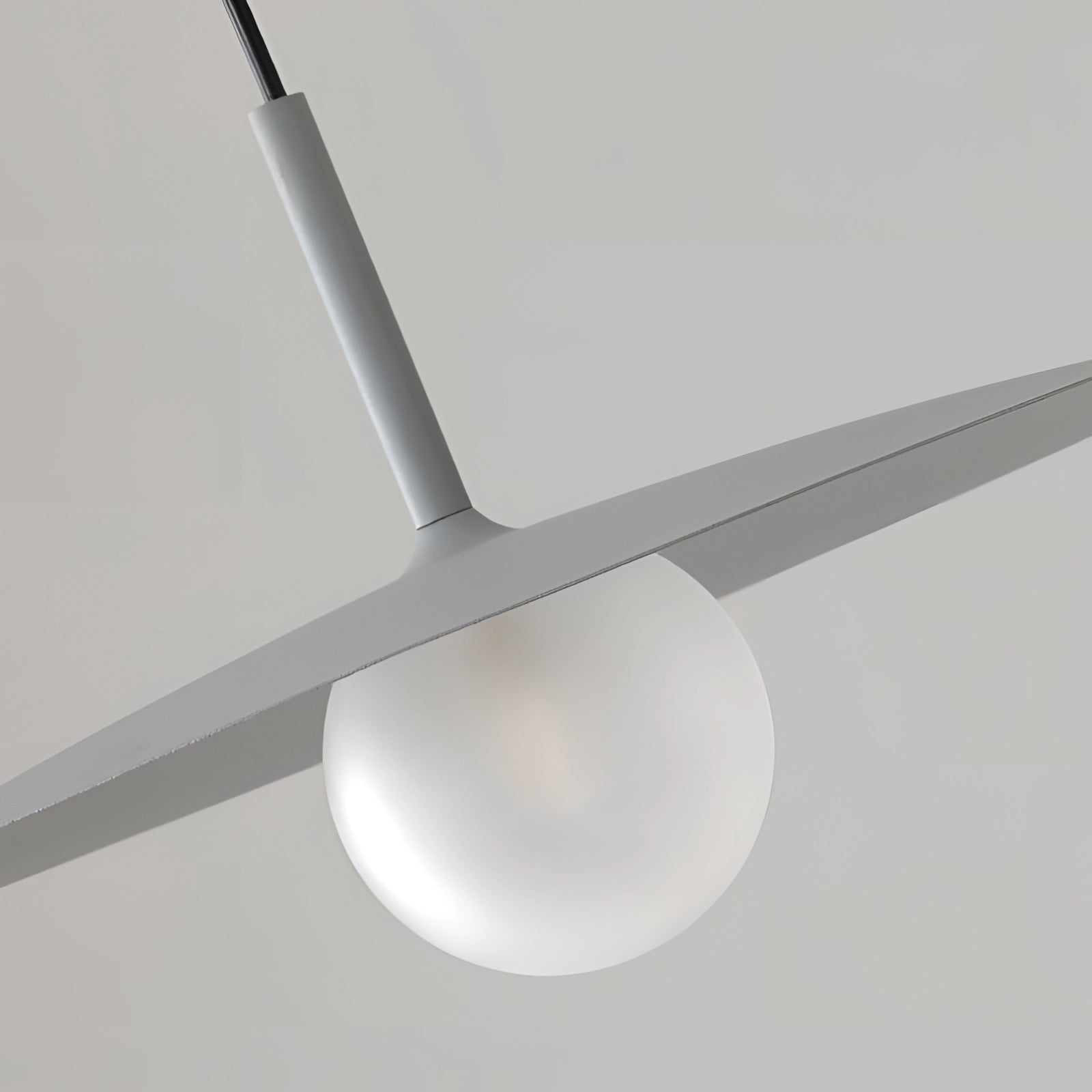 Minimalist black pendant lamp with a Scandinavian design, featuring a circular shape and crafted from durable materials such as metal, steel, and aluminum, hanging from the ceiling.