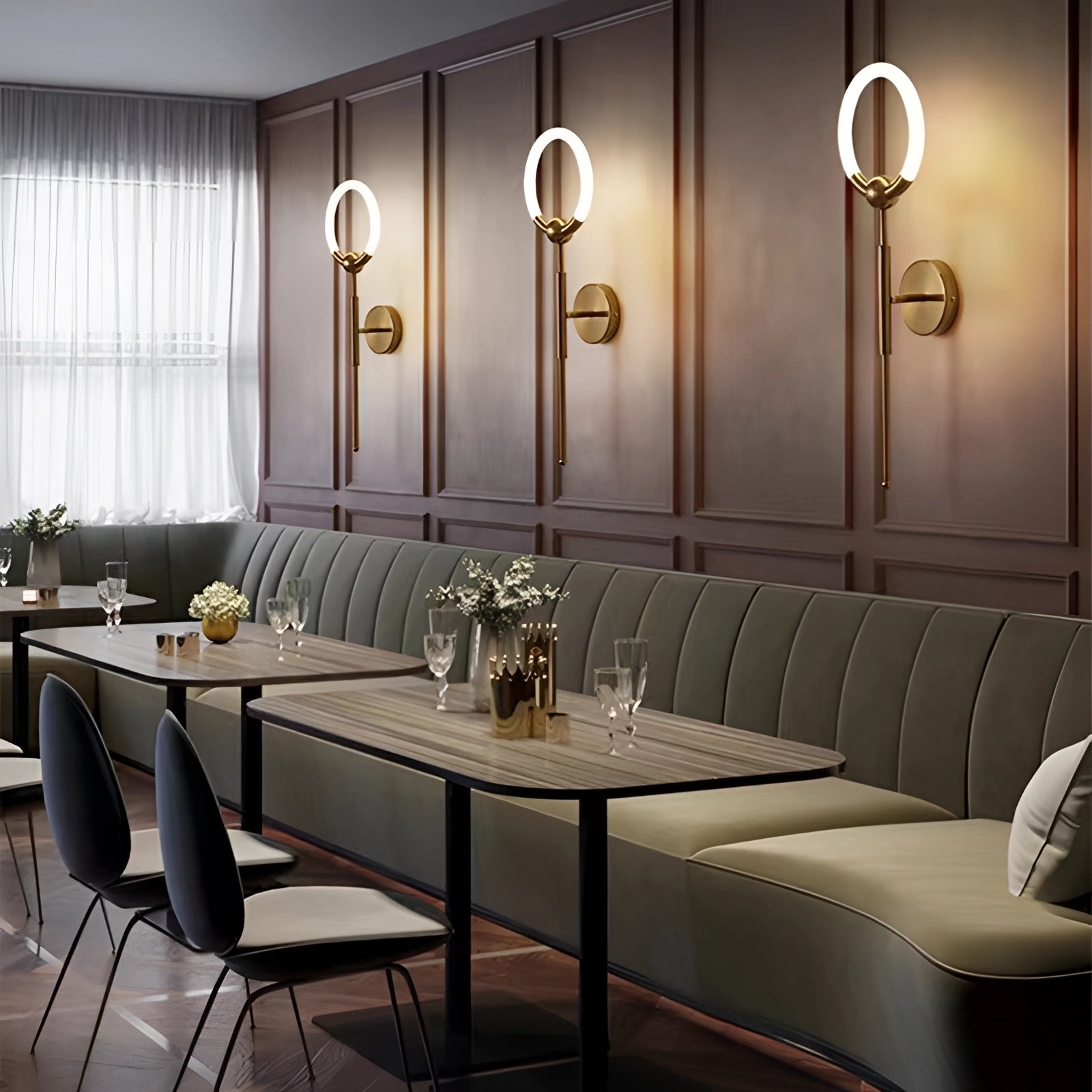 Minimalist Circular LED Wall Lamp in gold and black mounted on a modern interior wall, enhancing the contemporary decor with its sleek design and ambient lighting.