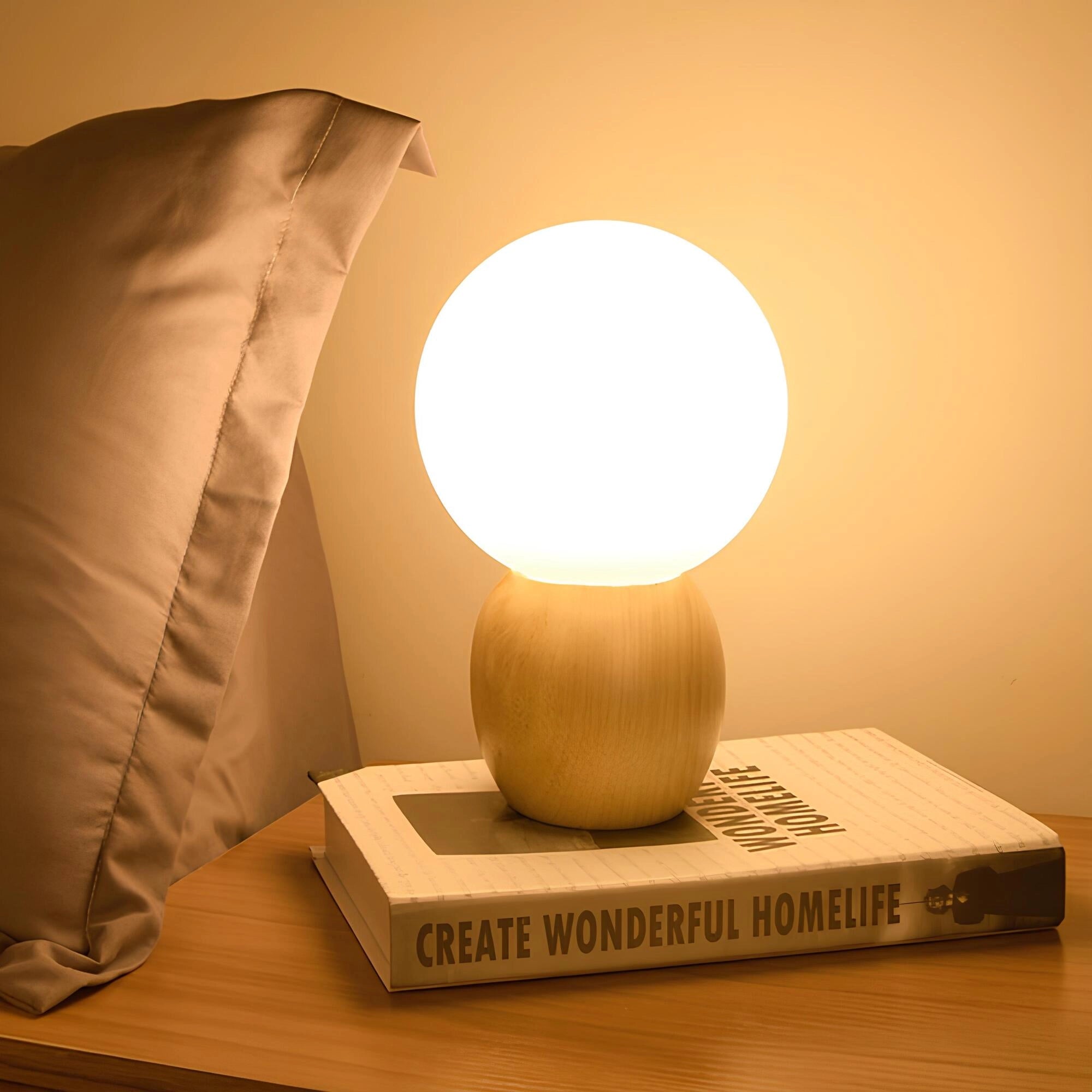 Minimalist glowing bedside lamp with a wooden base, emitting soft ambient light, placed on a desk against a neutral-toned wall.