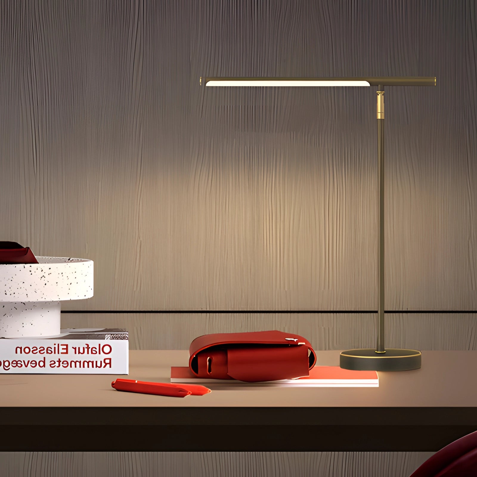 Minimalist gold LED desk lamp with an adjustable arm and energy-efficient light, featuring a sleek design suitable for modern interior spaces.