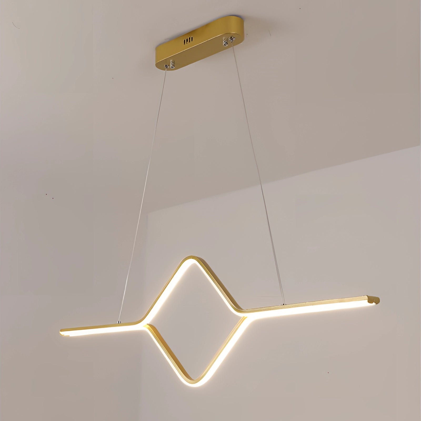 Minimalist gold geometric pendant light fixture with LED illumination, featuring a triangular and rectangular design, suspended from the ceiling with a modern aesthetic.