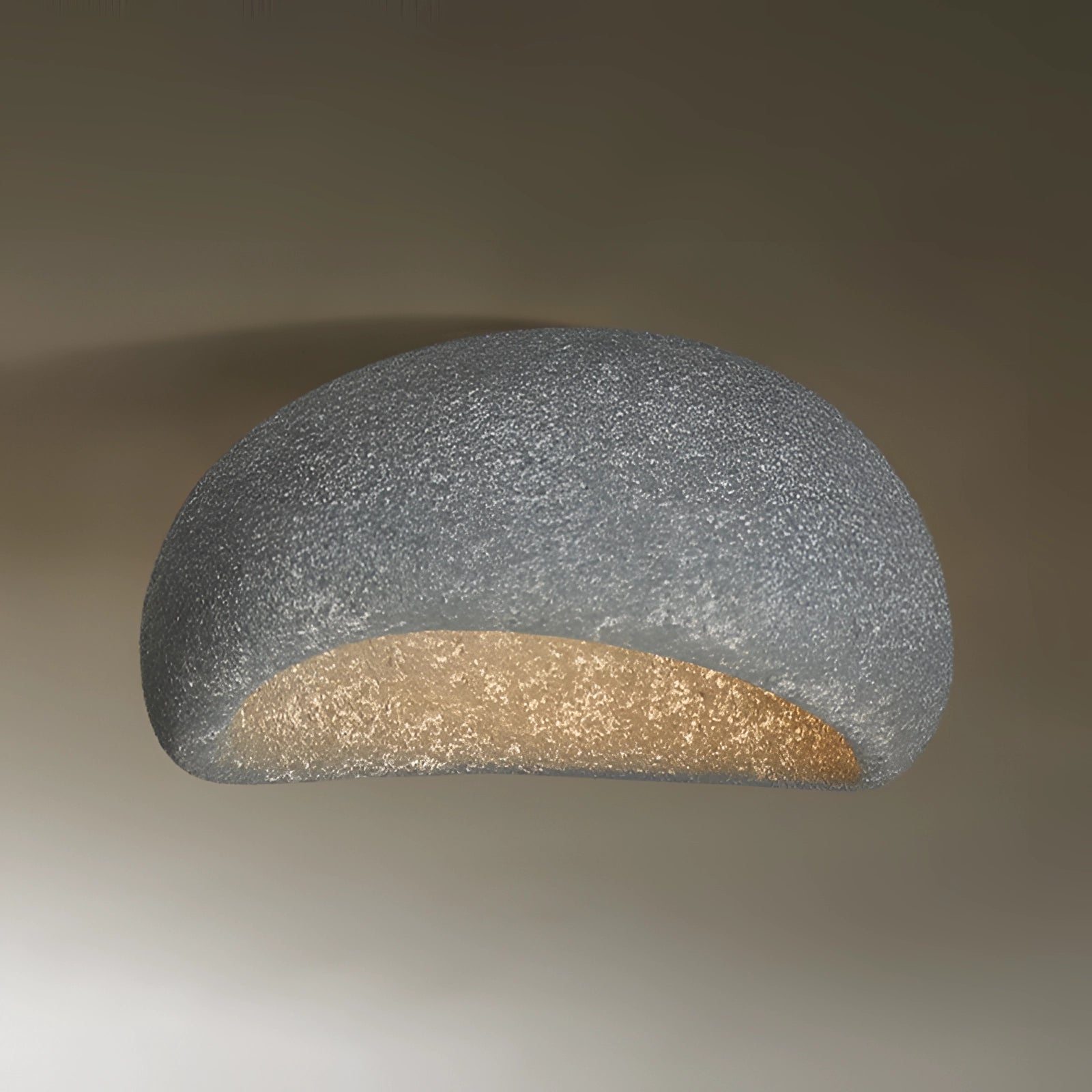 Minimalist Half-Moon Wall Sconce in dark gray with a 23.5" width, featuring a sleek metal design. The sconce is mounted on a wall, providing ambient interior lighting with a modern and understated aesthetic.