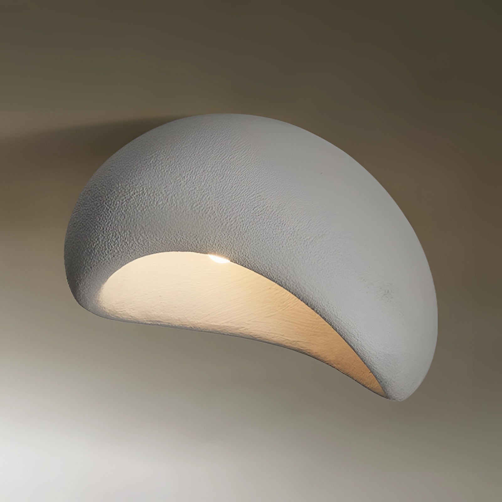 Minimalist half-moon wall sconce in gray with bevel connection, measuring 23.5 inches, designed for ambient interior lighting.