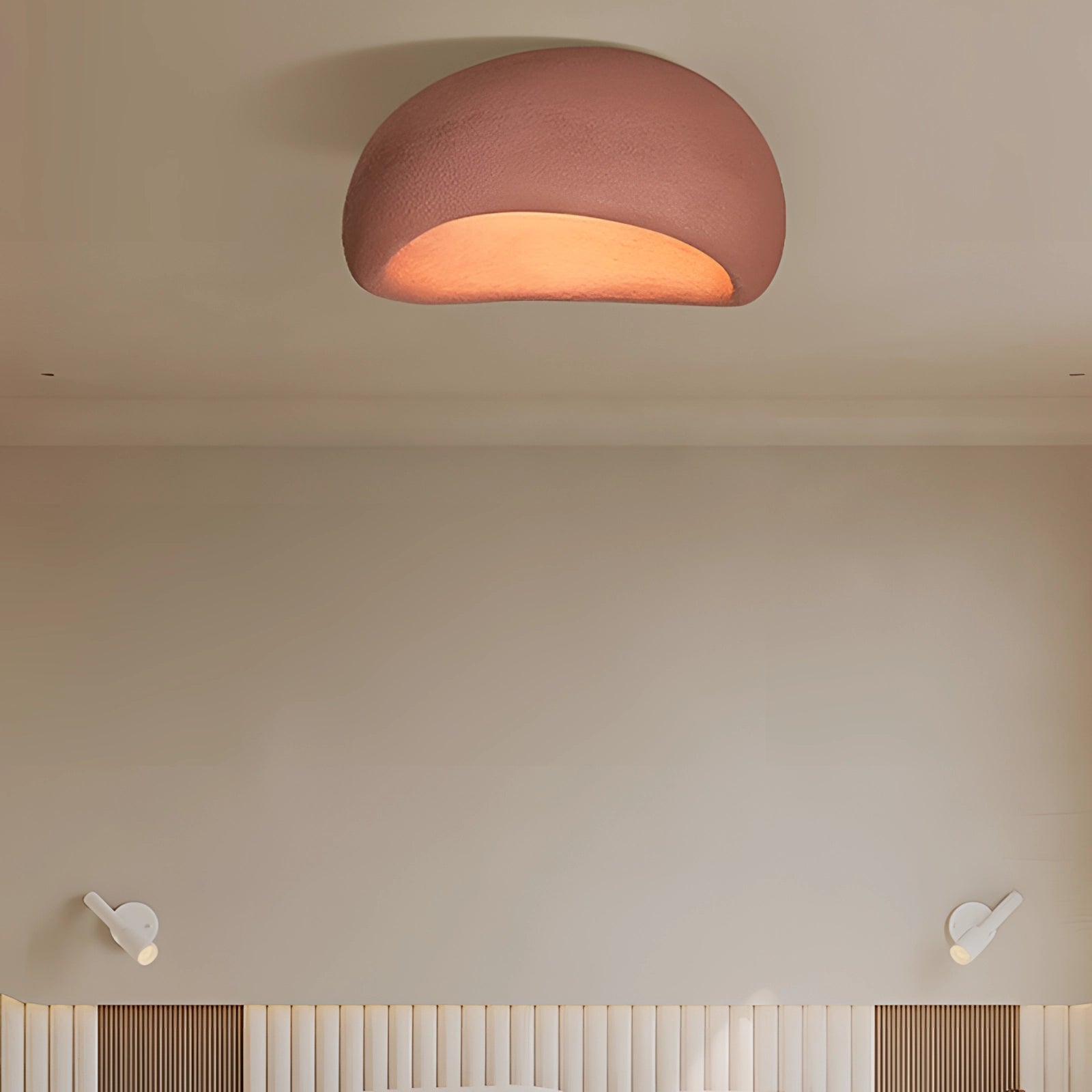 Minimalist half-moon wall sconce in red, measuring 23.5 inches, mounted on a wood paneled wall, providing ambient interior lighting with soft tints and shades.
