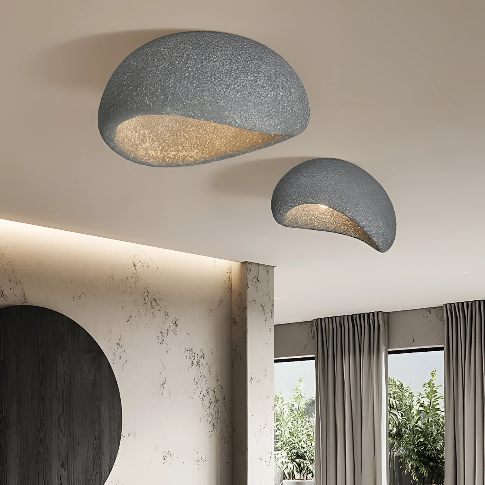 Minimalist half-moon wall sconce in dark gray with a bevel connection, measuring 23.5 inches, mounted on an interior wall, providing ambient lighting with a sleek design that enhances the architectural elements of the space.