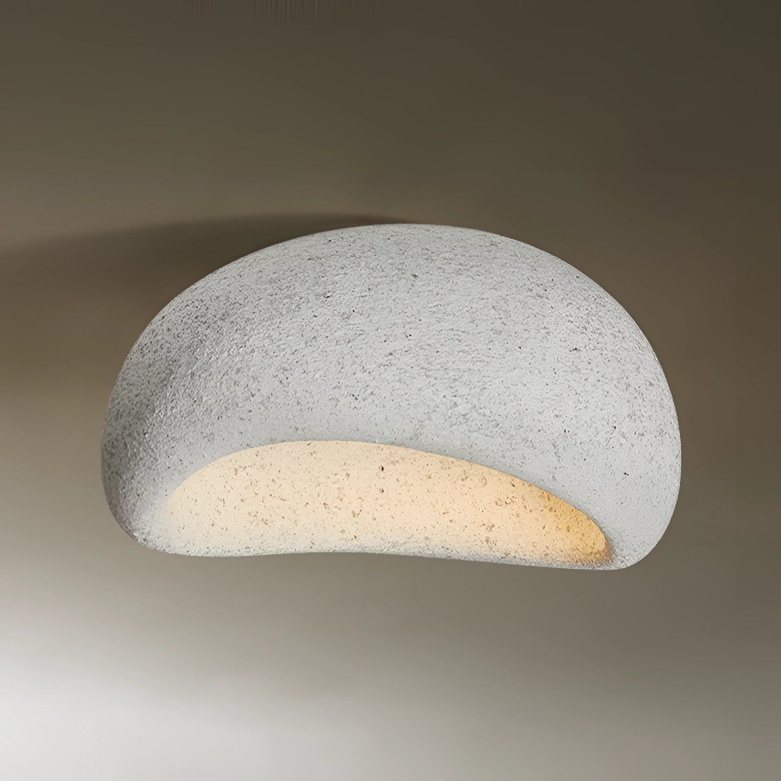 Minimalist half-moon wall sconce in light gray, measuring 23.5 inches, designed for ambient interior lighting. The sconce features a curved metal design resembling an astronomical object, suitable as a stylish and functional light fixture.