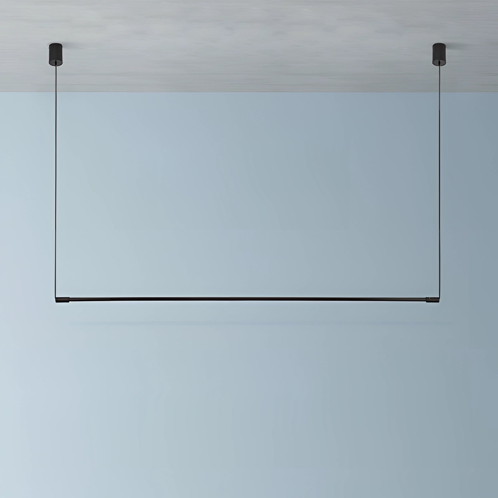 Minimalist LED pendant light hanging over a modern luxury dining and kitchen island with a sleek rectangular design.