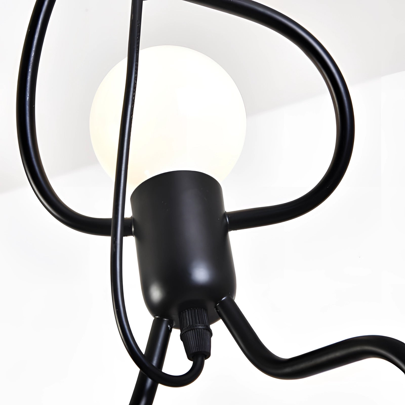 Minimalist modern pendant light with an adjustable metal ceiling fixture featuring sleek lines and a contemporary design.