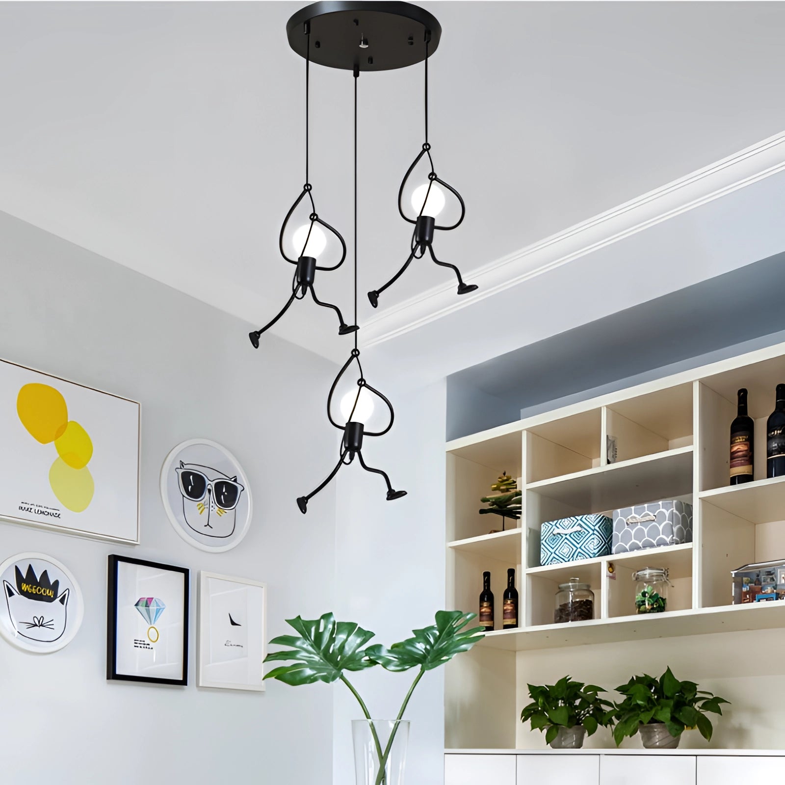 Minimalist modern pendant light with an adjustable metal ceiling fixture, illuminating a contemporary interior space with white walls, houseplants, and sleek shelving.