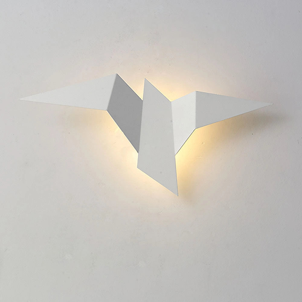 Minimalist origami bird-shaped LED wall lamp in white with a geometric modern design, featuring clean lines and a symmetrical shape, mounted on a wooden backing.
