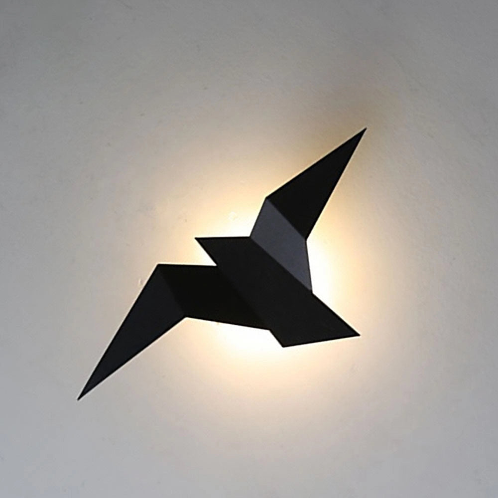 Minimalist black origami bird-shaped LED wall lamp with a geometric modern design mounted on a wall.