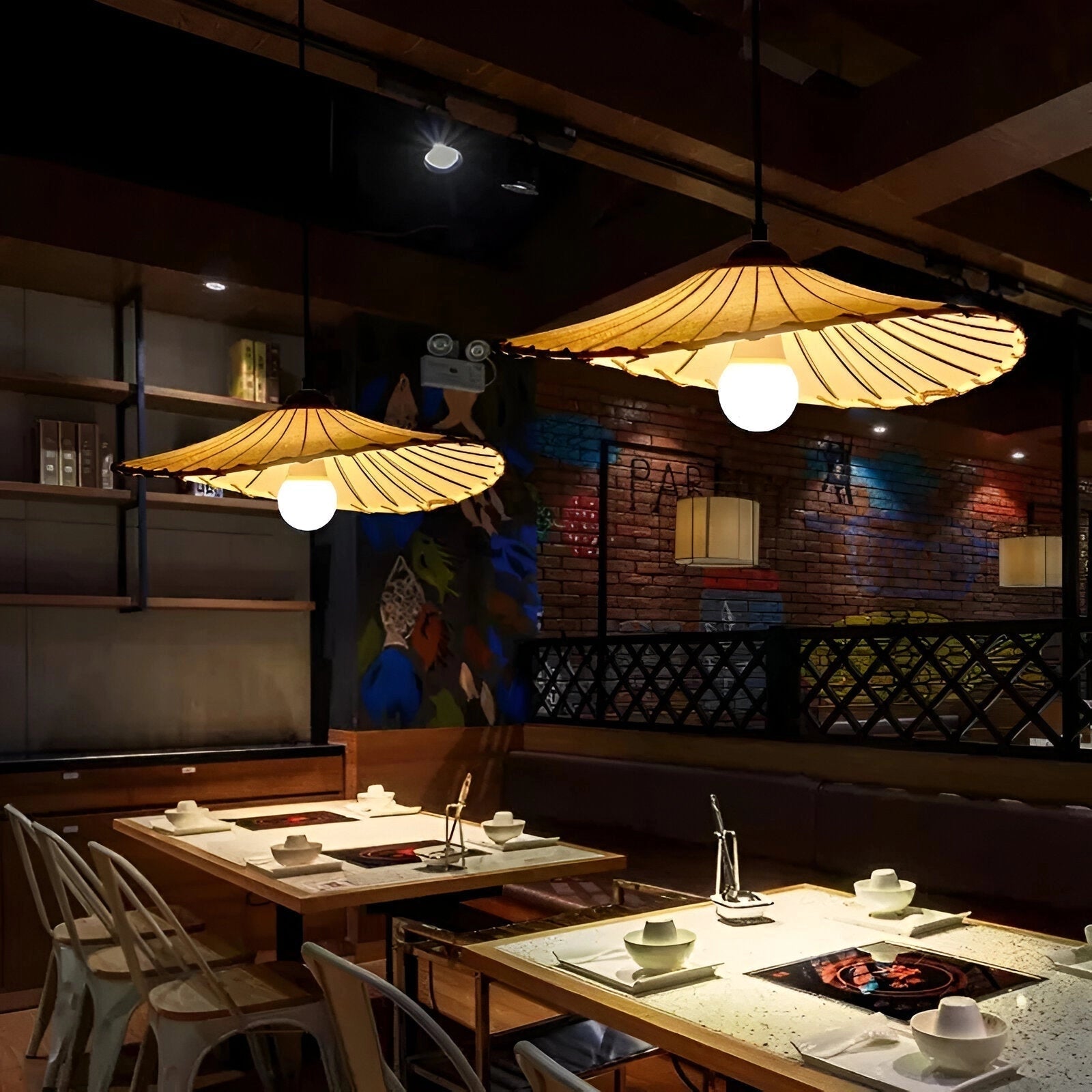 Minimalist Scandinavian pendant lamp with a wooden slat shade, hanging over a table in a modern interior setting.