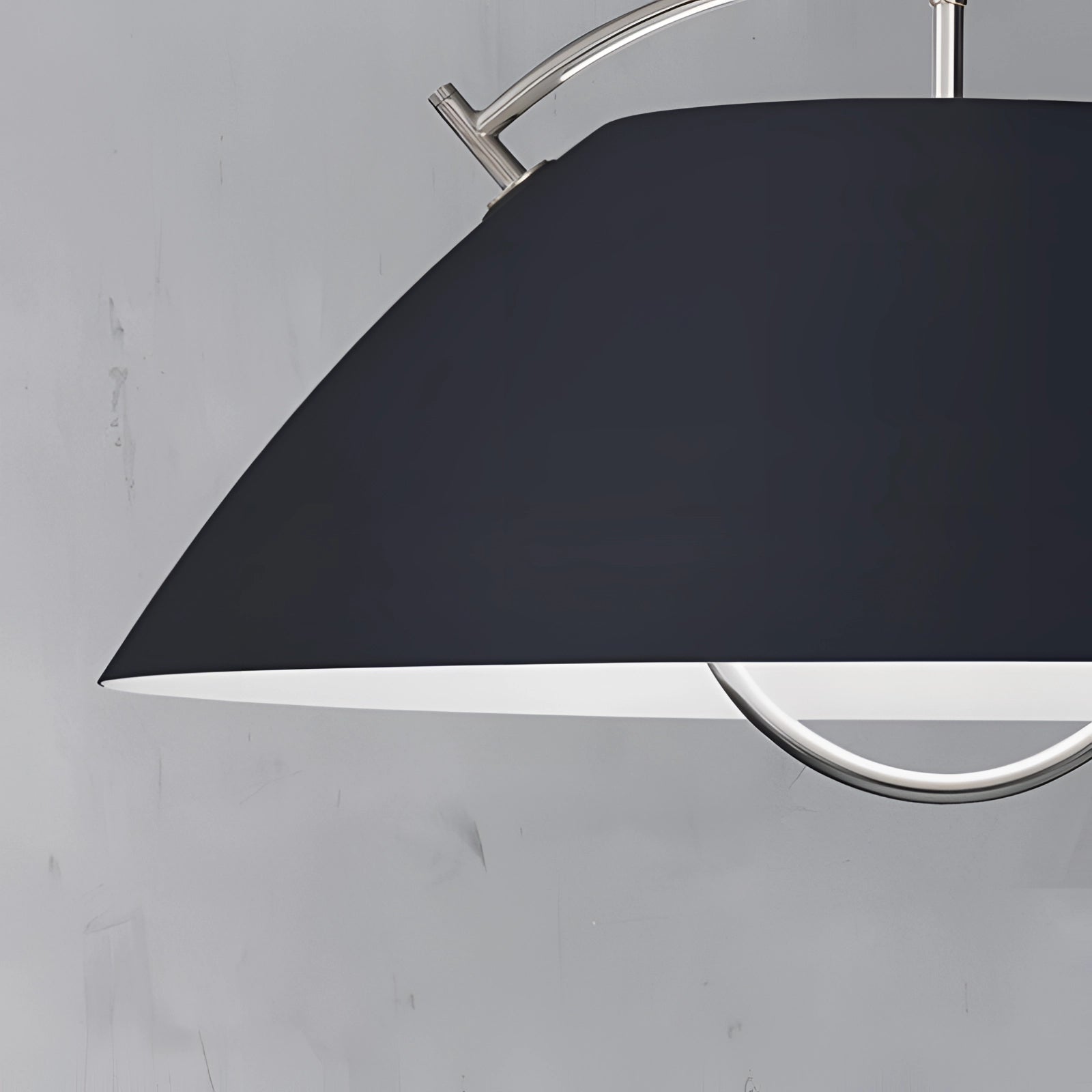 Minimalist Scandinavian white pendant light with a modern design, featuring an adjustable height and sleek geometric shape, hanging from the ceiling.