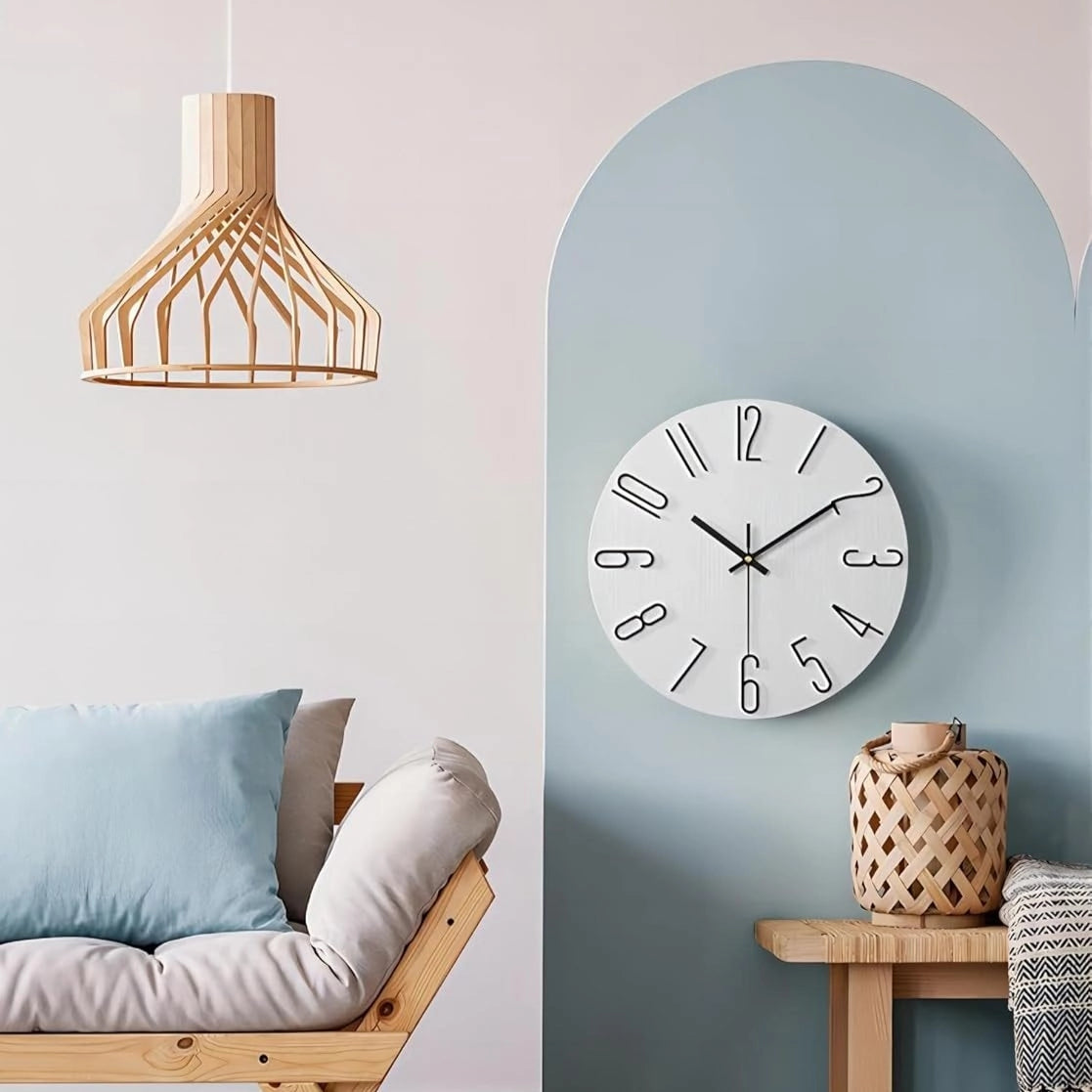Minimalist soft pink Scandinavian wall clock with a modern design, featuring a clean white face and sleek wooden frame, suitable for contemporary interior decor.