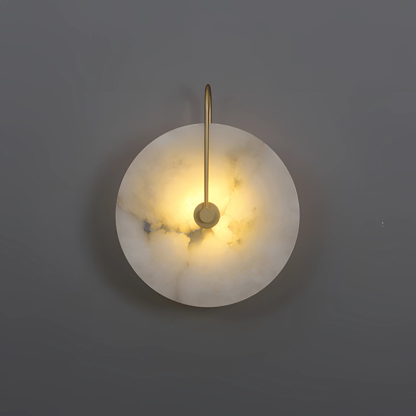 Minimalist white alabaster wall lamp with a modern luxury design, featuring a smooth circular shape, mounted on a wall against a clear sky background.