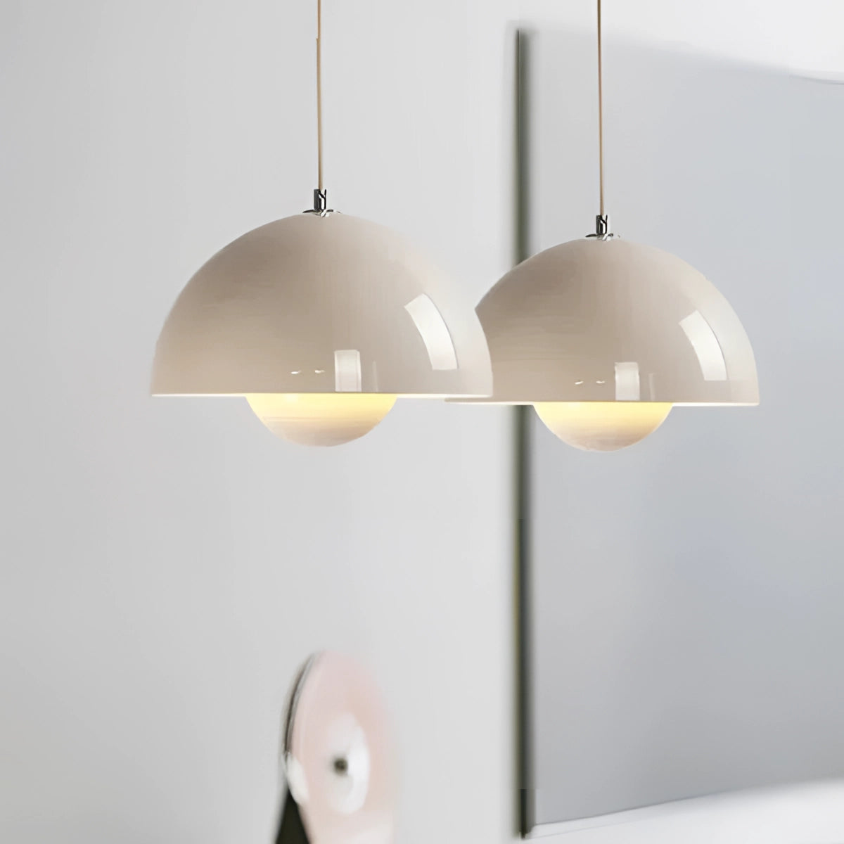 Minimalist white dome pendant light hanging from the ceiling, featuring a Scandinavian design with a smooth, white lampshade and wooden accents, suitable for dining and kitchen spaces.