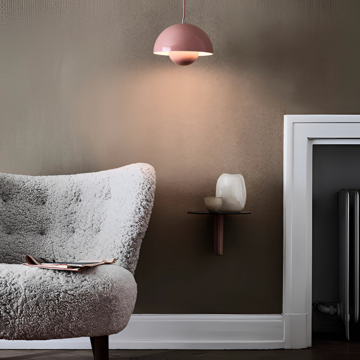 Minimalist white dome pendant light with a smooth, rounded shade, hanging from a wooden fixture, illuminating a Scandinavian-style dining or kitchen space with a soft, cozy ambiance.