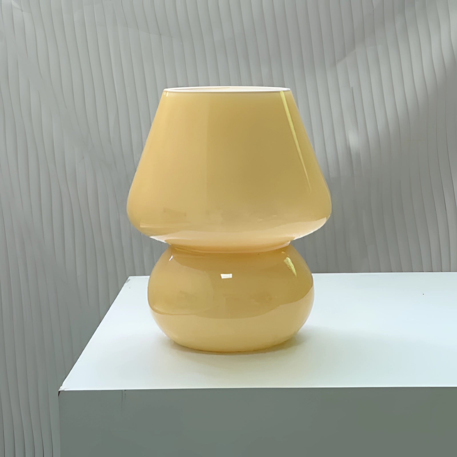 Modern 3D printed white swirl LED table lamp with a yellow solid lampshade, featuring an elegant circular design. The energy-efficient lamp is crafted with hints of beige and wood-like textures, resembling an artistic artifact, designed to complement contemporary interiors.