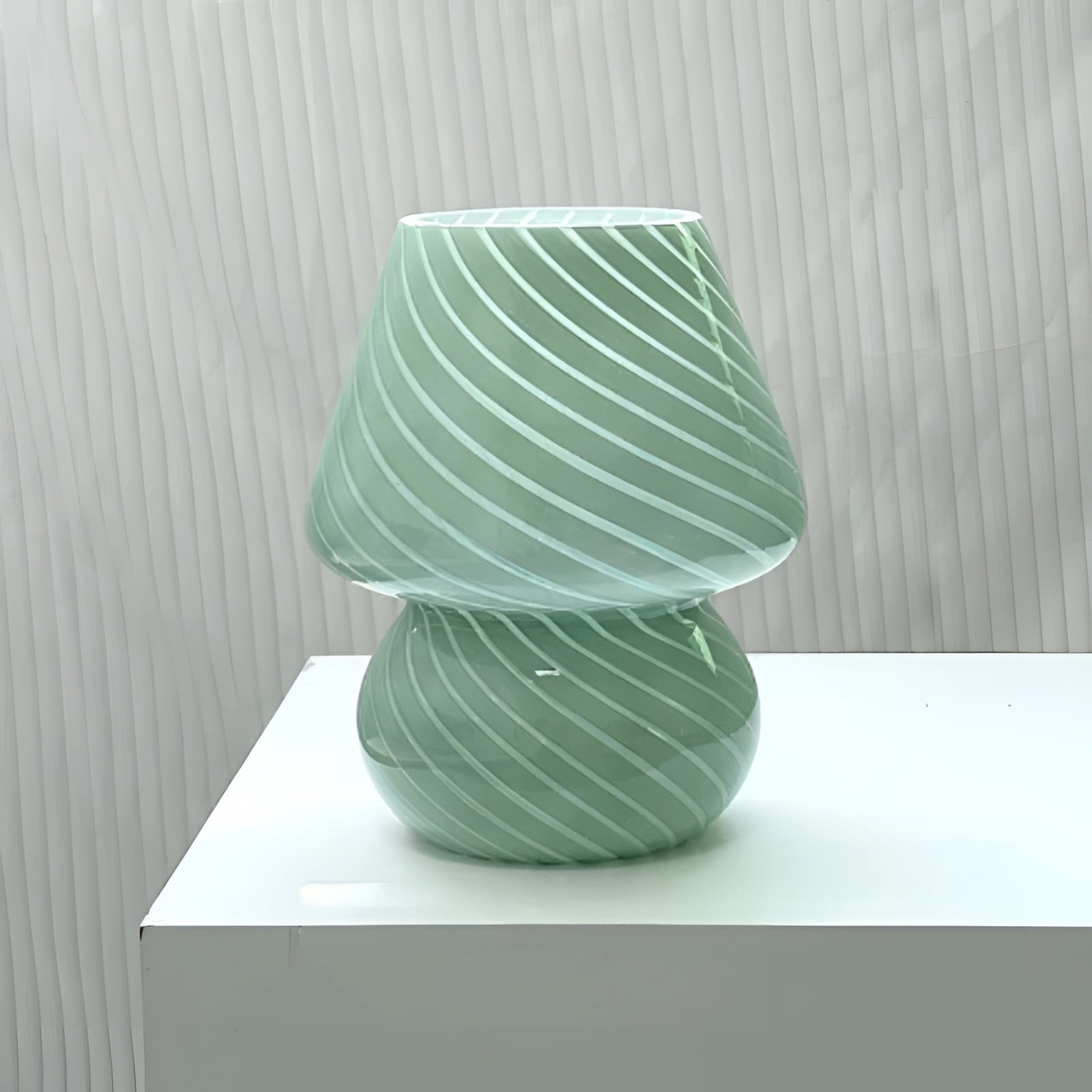 Modern 3D printed white swirl LED table lamp with an energy-efficient design, featuring a unique artistic pattern that resembles a vase, placed on a wooden surface.