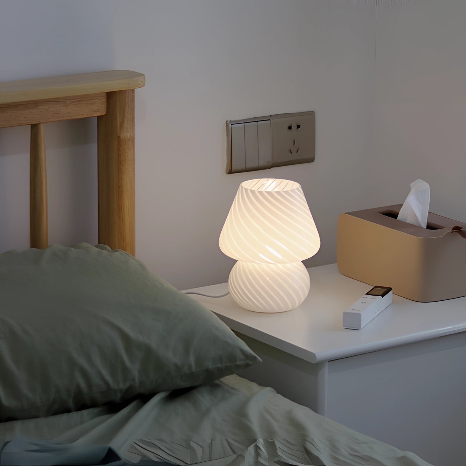 Modern 3D printed white swirl LED table lamp placed on a wooden table, surrounded by contemporary furniture and neutral-toned decor.