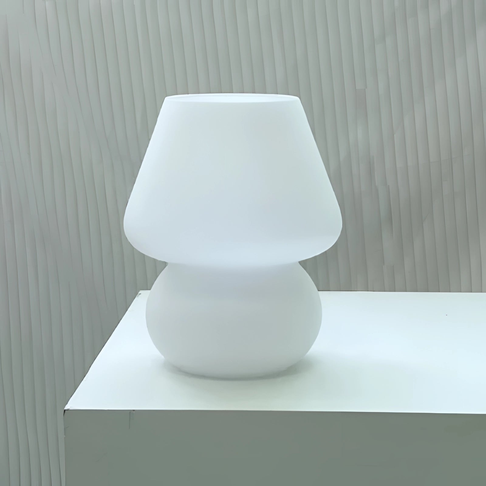 A modern 3D printed table lamp with a sleek white swirl design and integrated LED lights, noted for its energy efficiency and contemporary style.