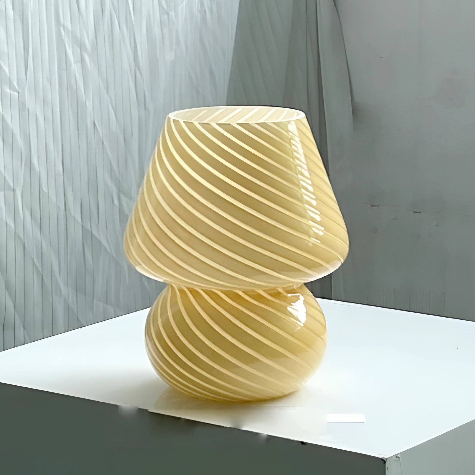 Modern 3D printed white swirl LED table lamp with a yellow swirl design, placed on a wooden rectangular table.