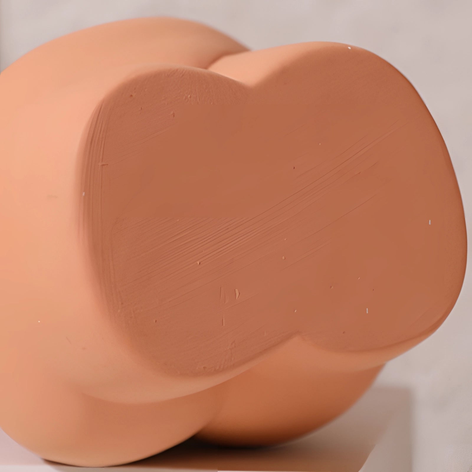 Modern abstract female form vases with art deco body-shaped design in shades of carmine and peach, crafted from clay.