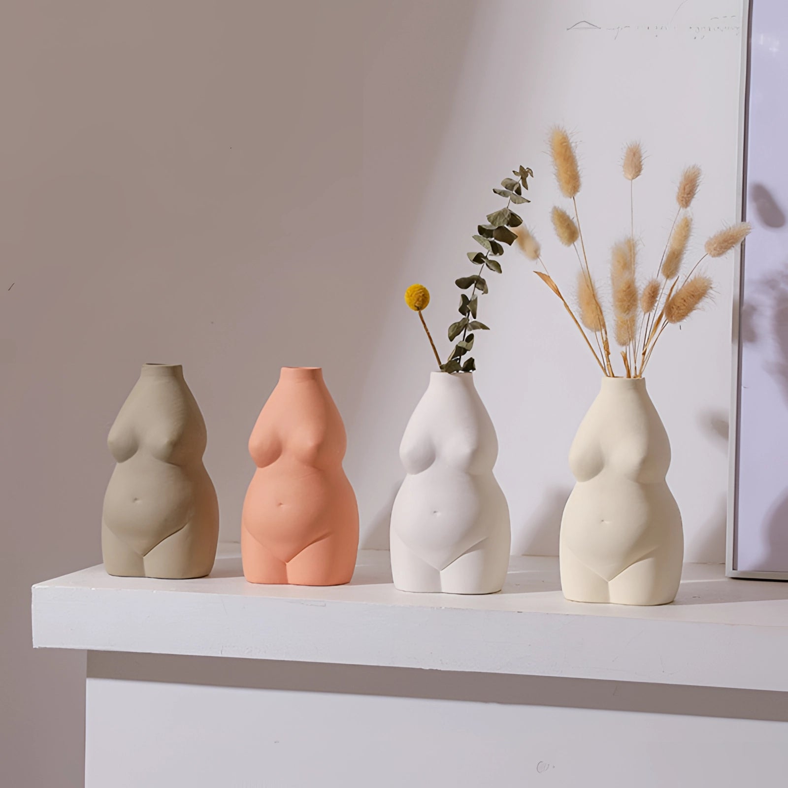 Modern abstract female form vases in an art deco style, featuring body-shaped designs crafted from ceramic material, creatively blending artistic elements with functional serveware or pottery.