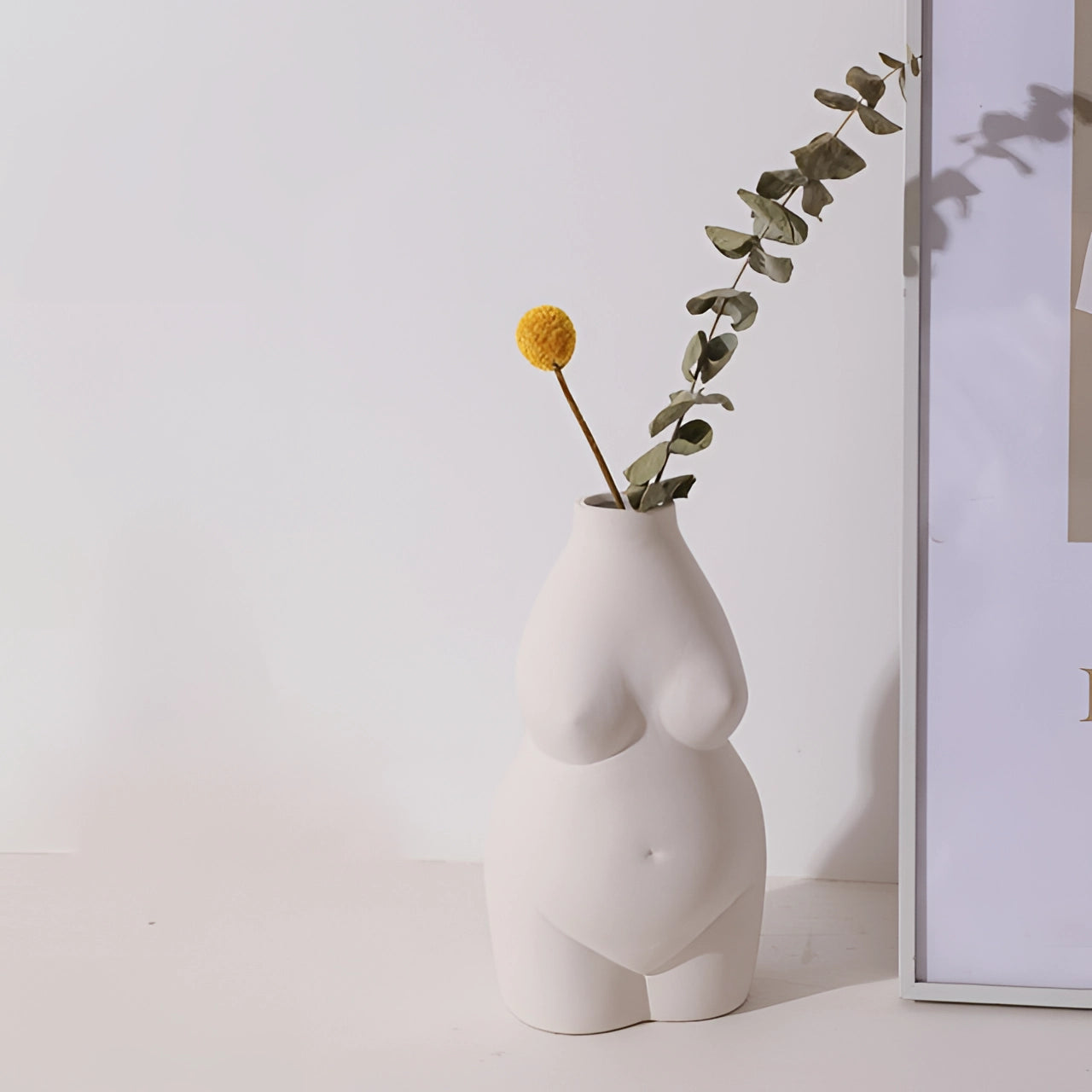Modern abstract female form vase in white with an art deco body-shaped design, featuring a curvaceous silhouette.