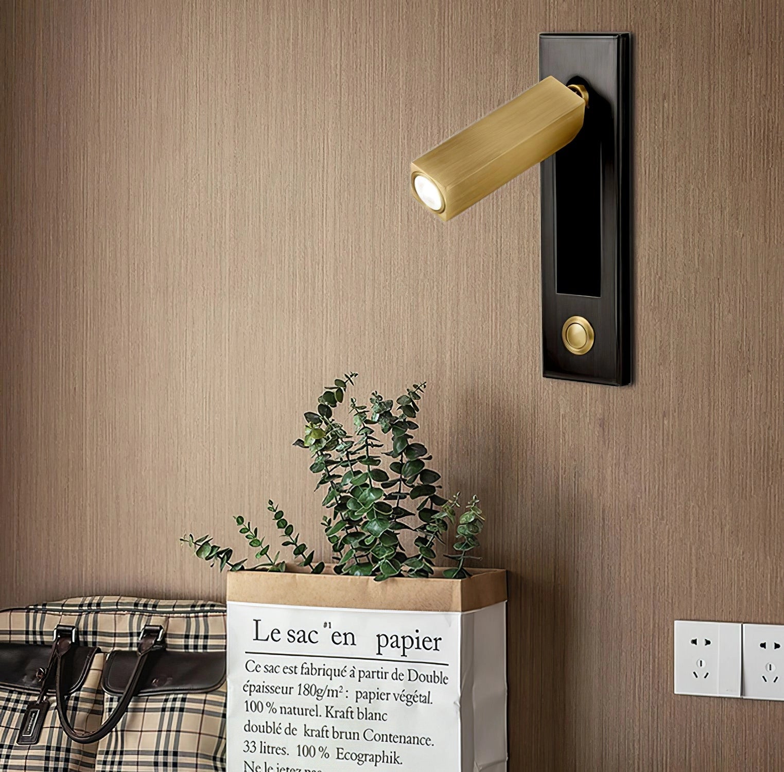Modern adjustable black LED wall light with motion sensor, mounted on a wood-paneled exterior wall near a door.