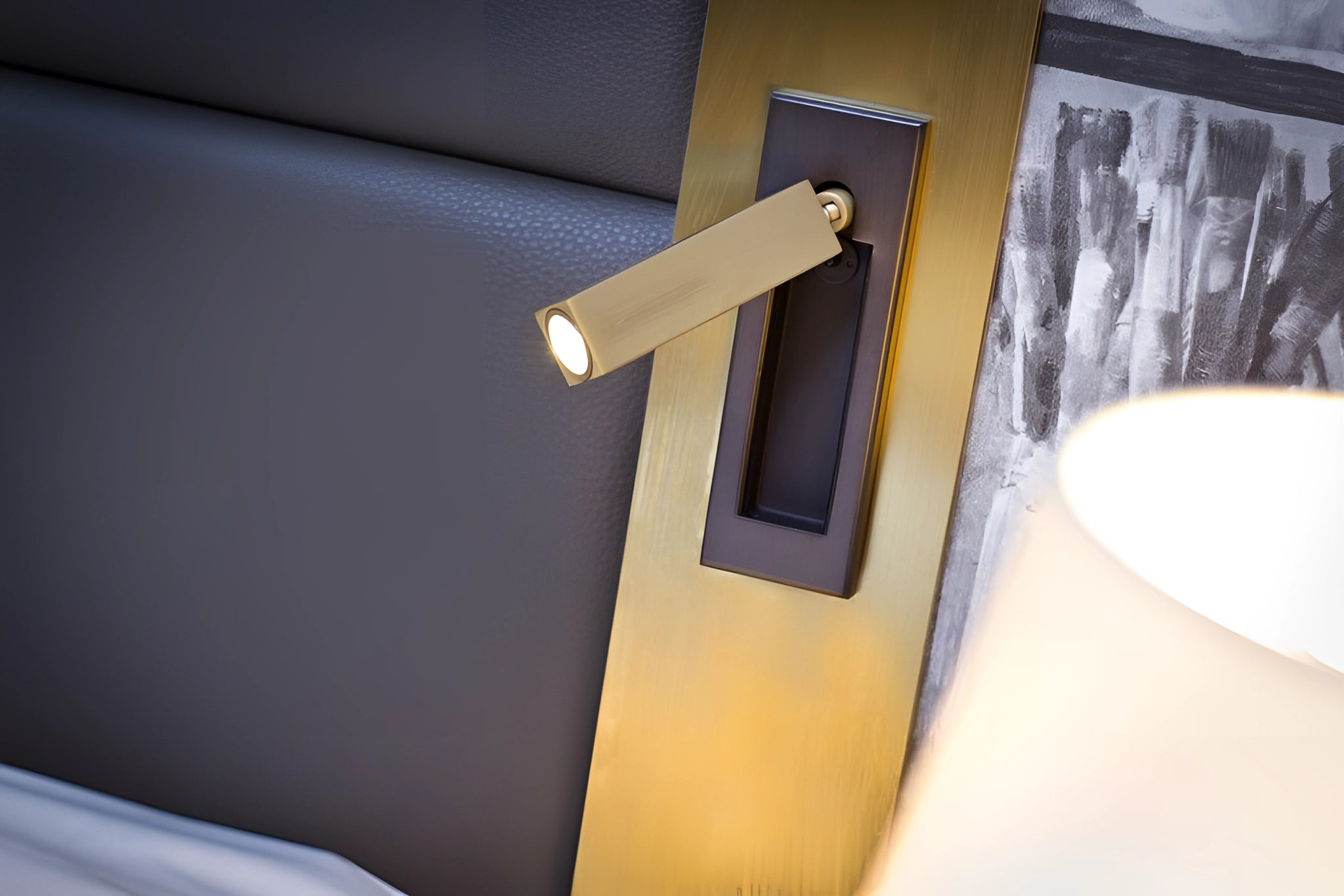 Modern adjustable black LED wall light with weather-resistant finish and motion sensor, mounted on wooden exterior.