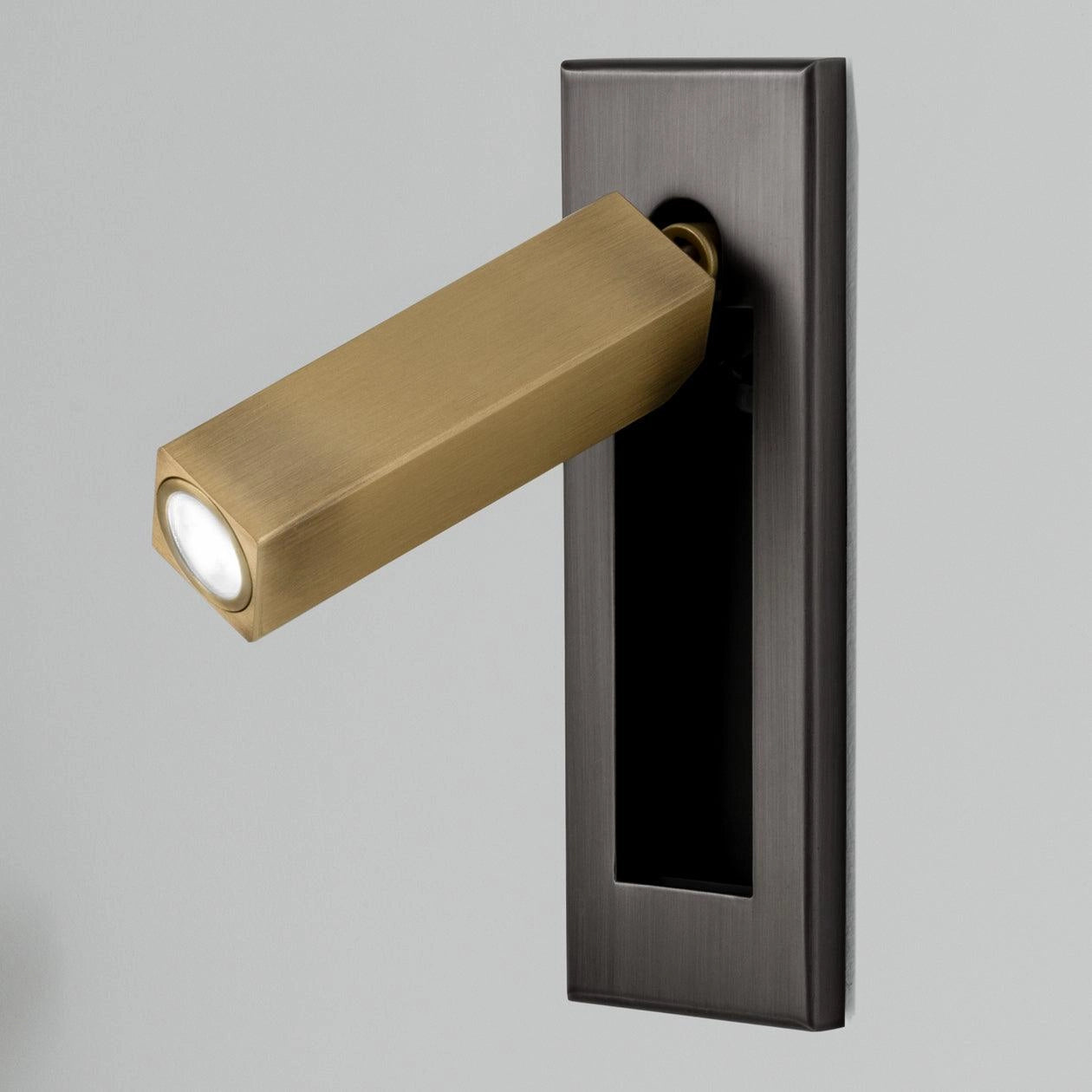 Modern adjustable LED wall light set of 2 in matte black and copper, featuring a rectangular design with motion sensor, cool white illumination, and weather-resistant finish, mounted on a wooden surface.