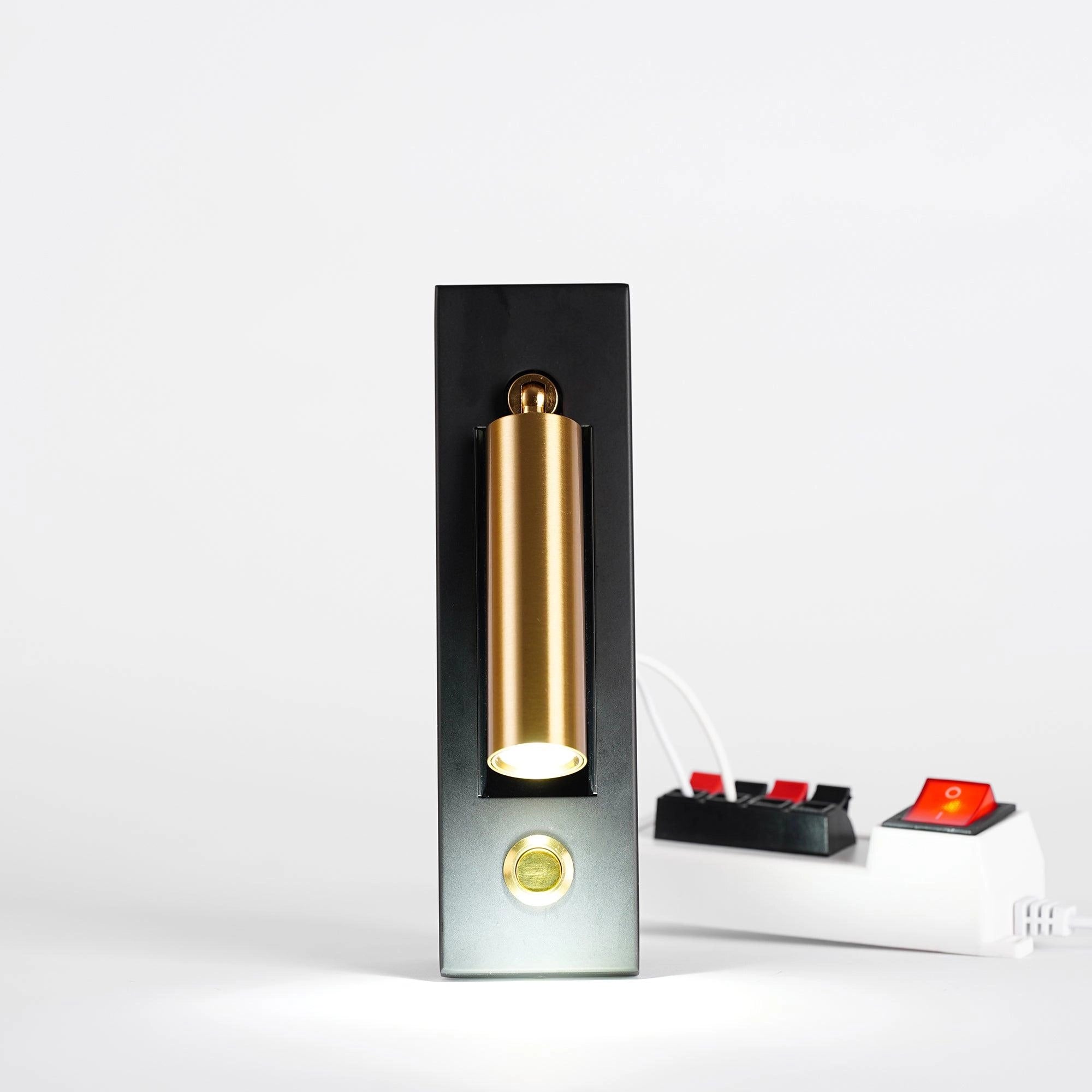 Modern black adjustable LED wall light with motion sensor, rectangular and weather-resistant, mounted on an exterior wall.
