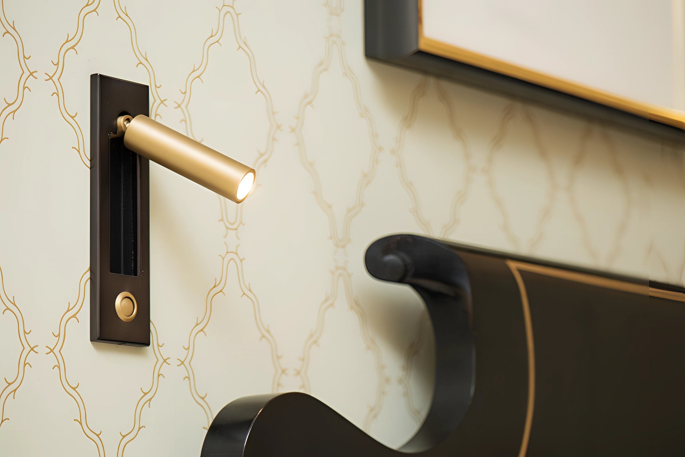 A sleek black weather-resistant LED wall light with an adjustable design and motion sensor, mounted on an exterior wall.