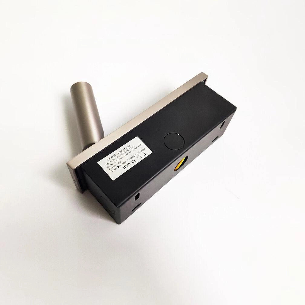 Modern black adjustable LED wall light with weather-resistant design and motion sensor, mounted on an outdoor wall.