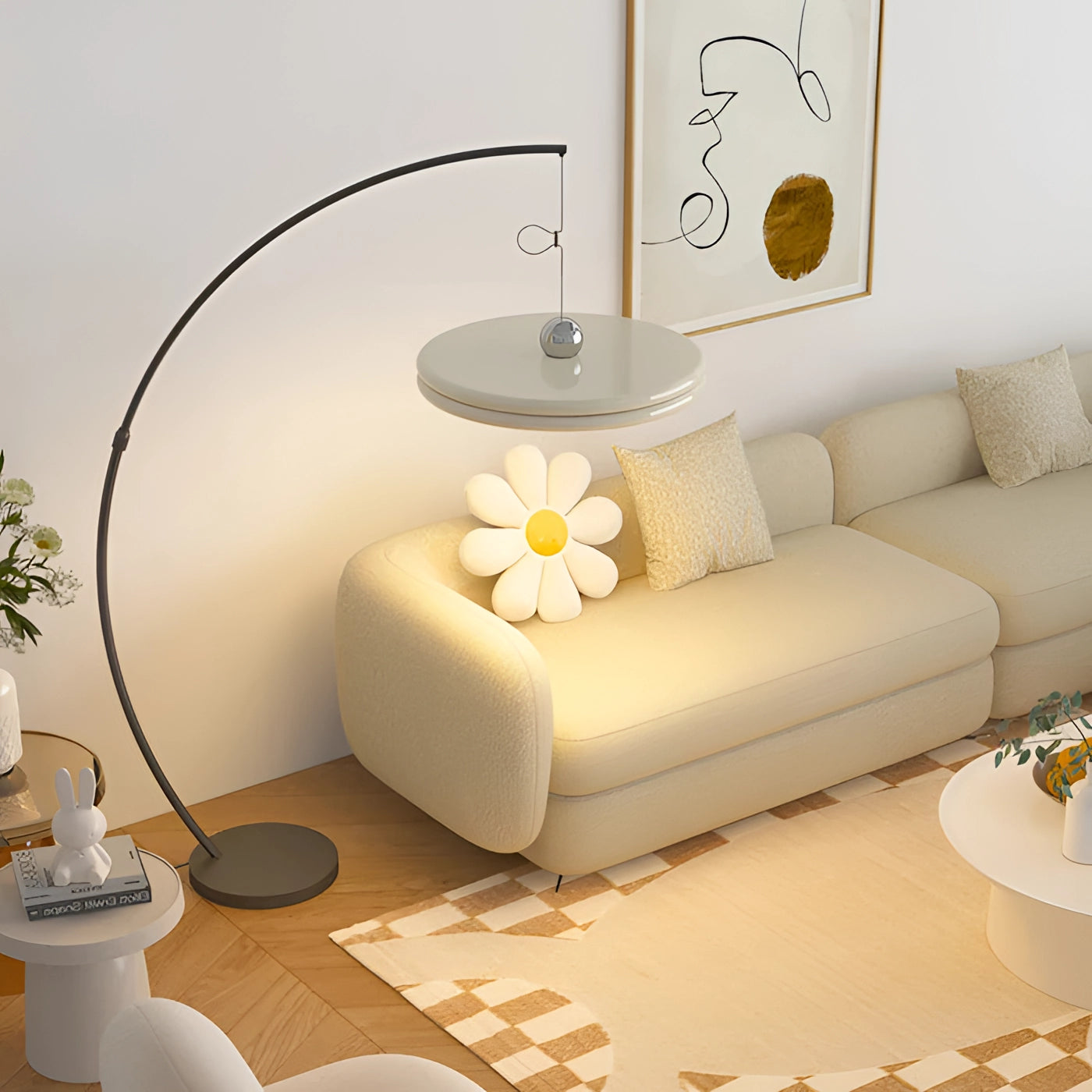Modern arched floor lamp with a curved metallic finish and a large white shade, positioned in a stylish living room next to a comfortable couch and decorative plants.