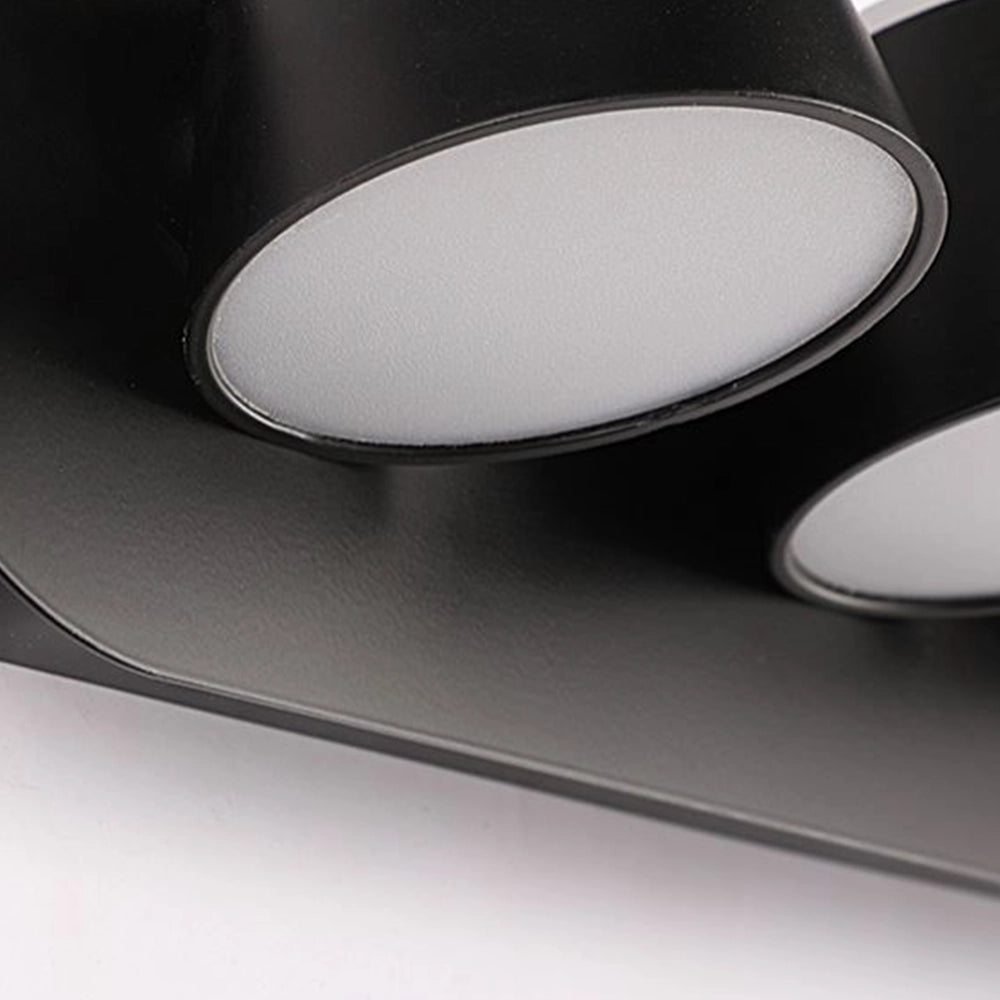 Modern black adjustable 4-light LED track light fixture with sleek, energy-efficient design, featuring four cylindrical lights mounted on a straight bar.