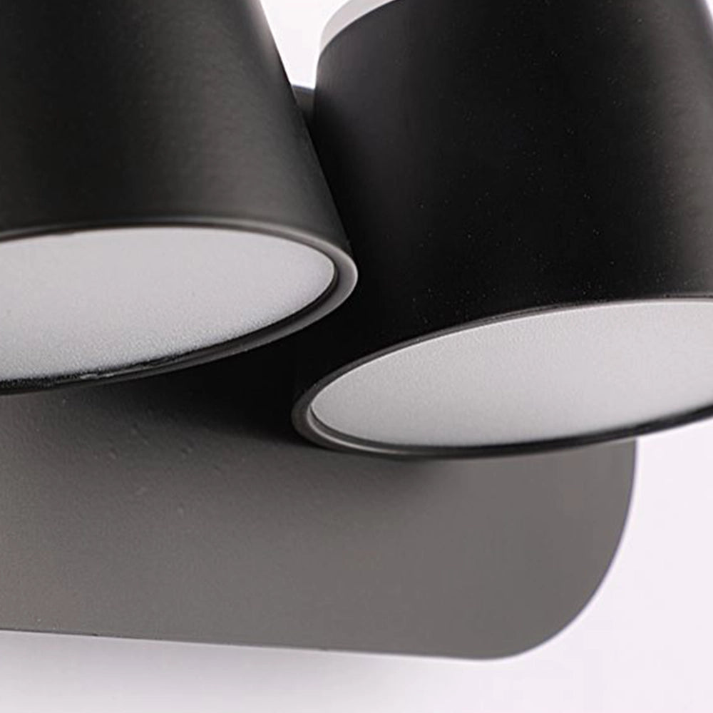 Modern black adjustable 4-light LED track light installed in a contemporary interior setting, illuminating a room with sleek and energy-efficient design.