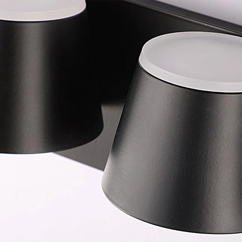 Modern black adjustable 4-light LED track light mounted on ceiling, featuring cylindrical light heads and a rectangular base, designed for energy efficiency.